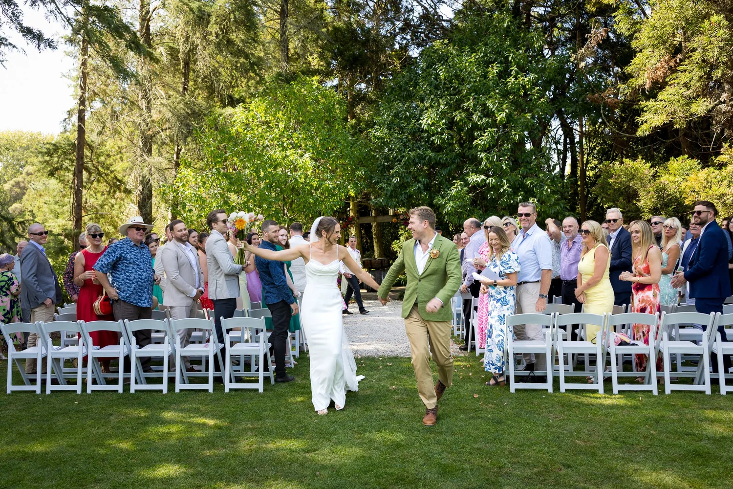 Jade and Ben celebrate as they leave the ceremony