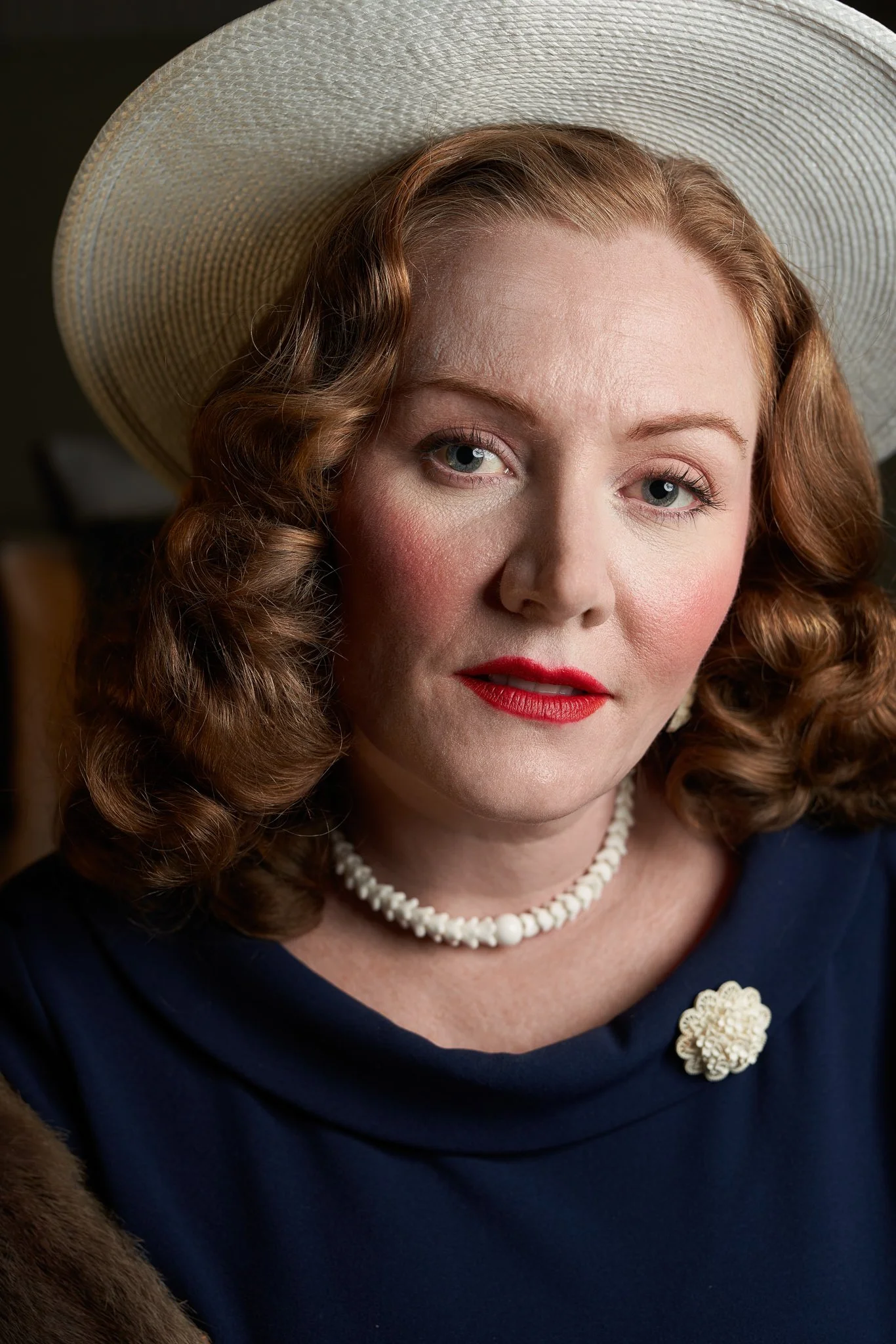 Laura in a white hat and pearls