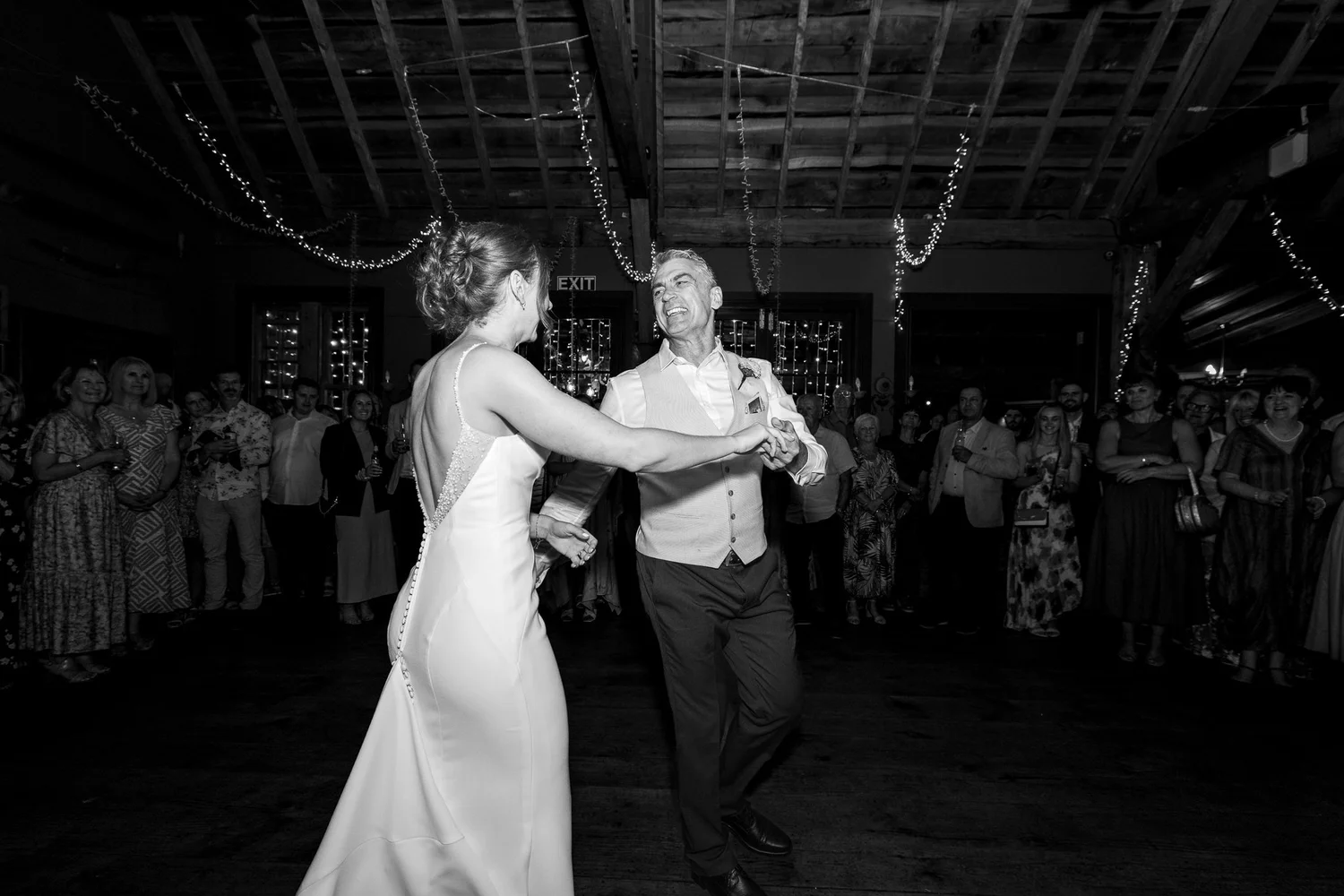 Black and white photo of Jade and Ben dancing in the barn