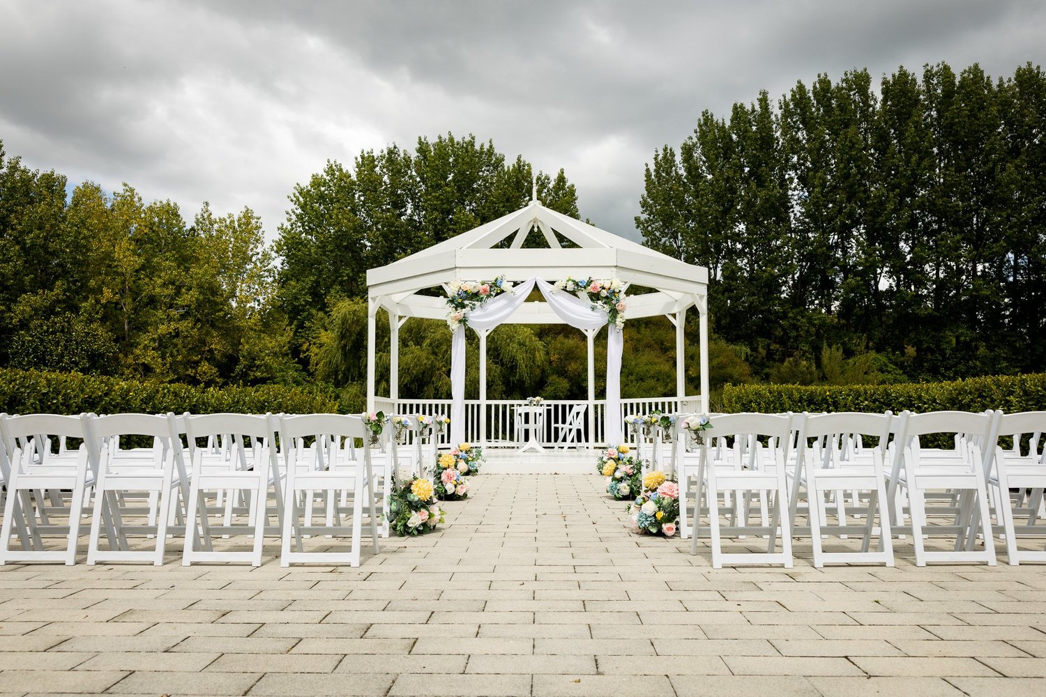 The white gazebo and ceremony seating in the gardens