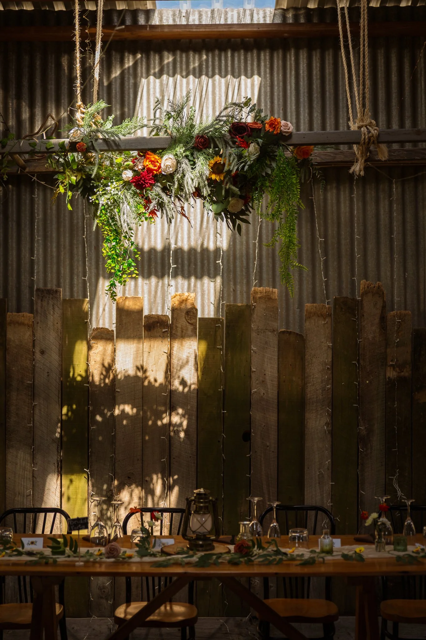 A hanging floral installation above the reception tables
