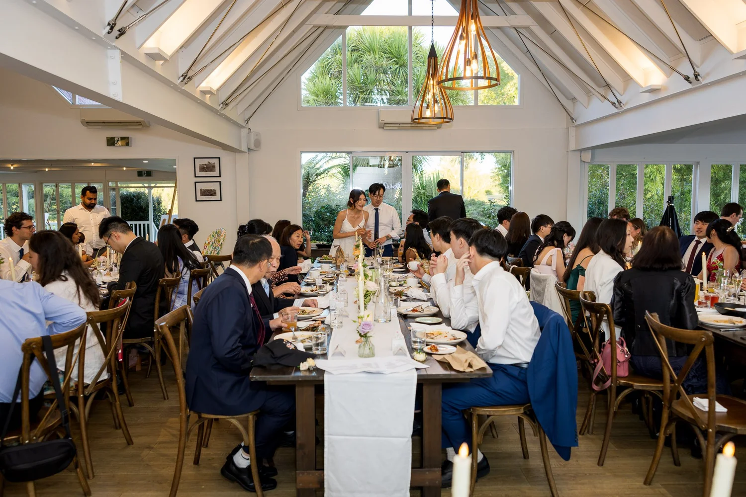 Guests at long reception tables in the dining room