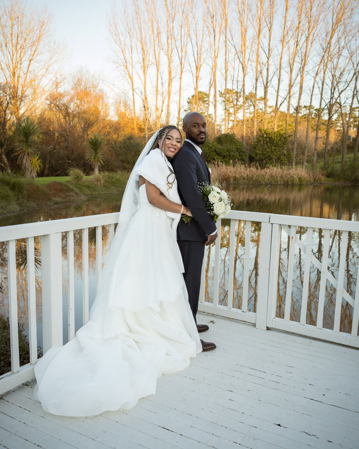 Chiedza and Foster on the rotunda by the lake at sunset