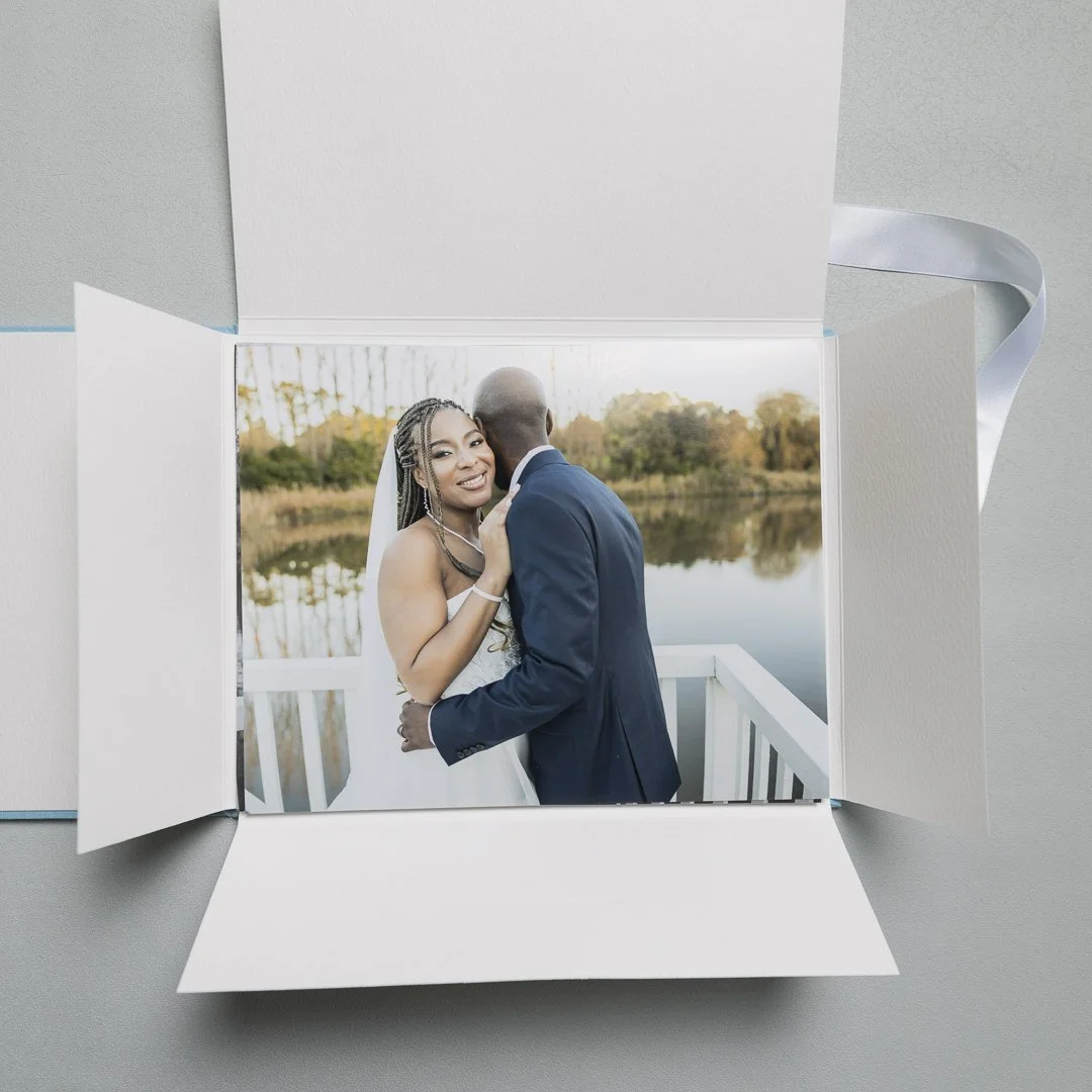 A printed wedding photo presented in a white folio box