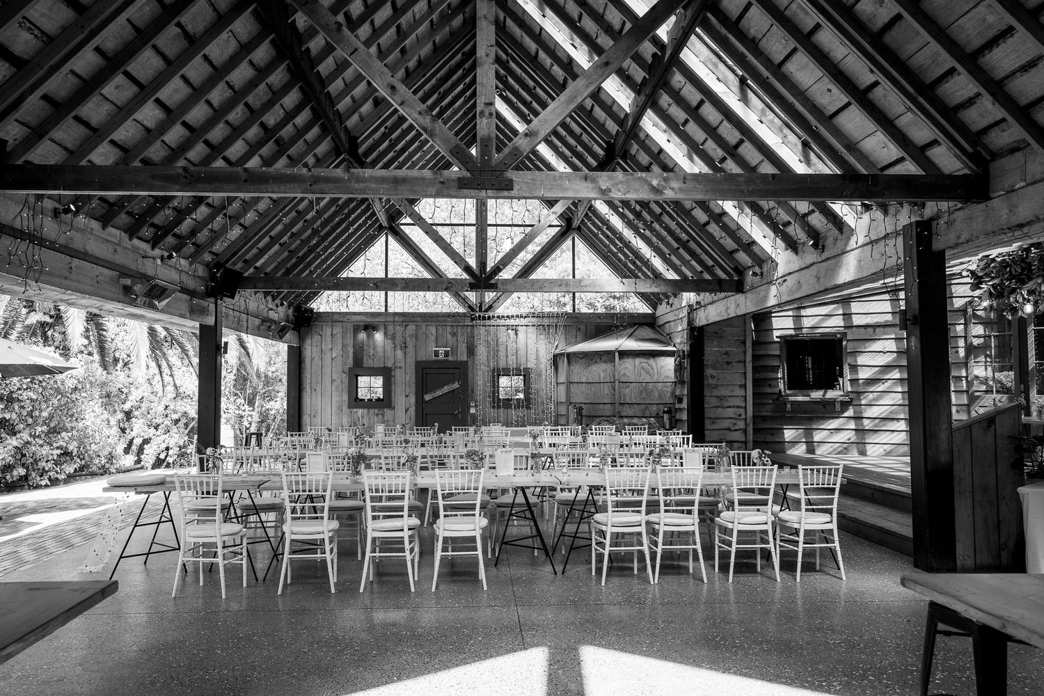 Black and white photo of the open-sided barn set for the reception
