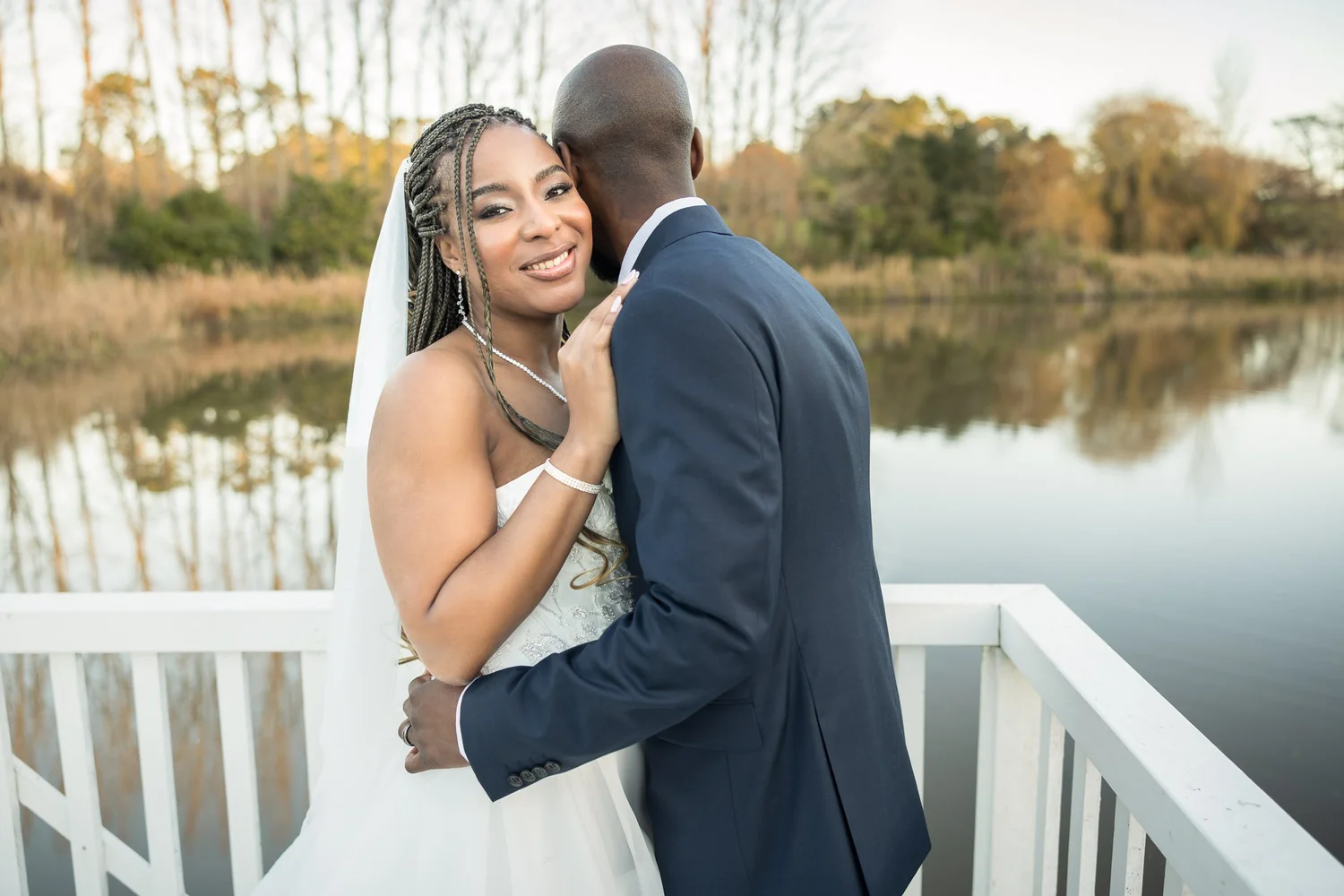Chiedza and Foster embrace by the lake at Abel Estate
