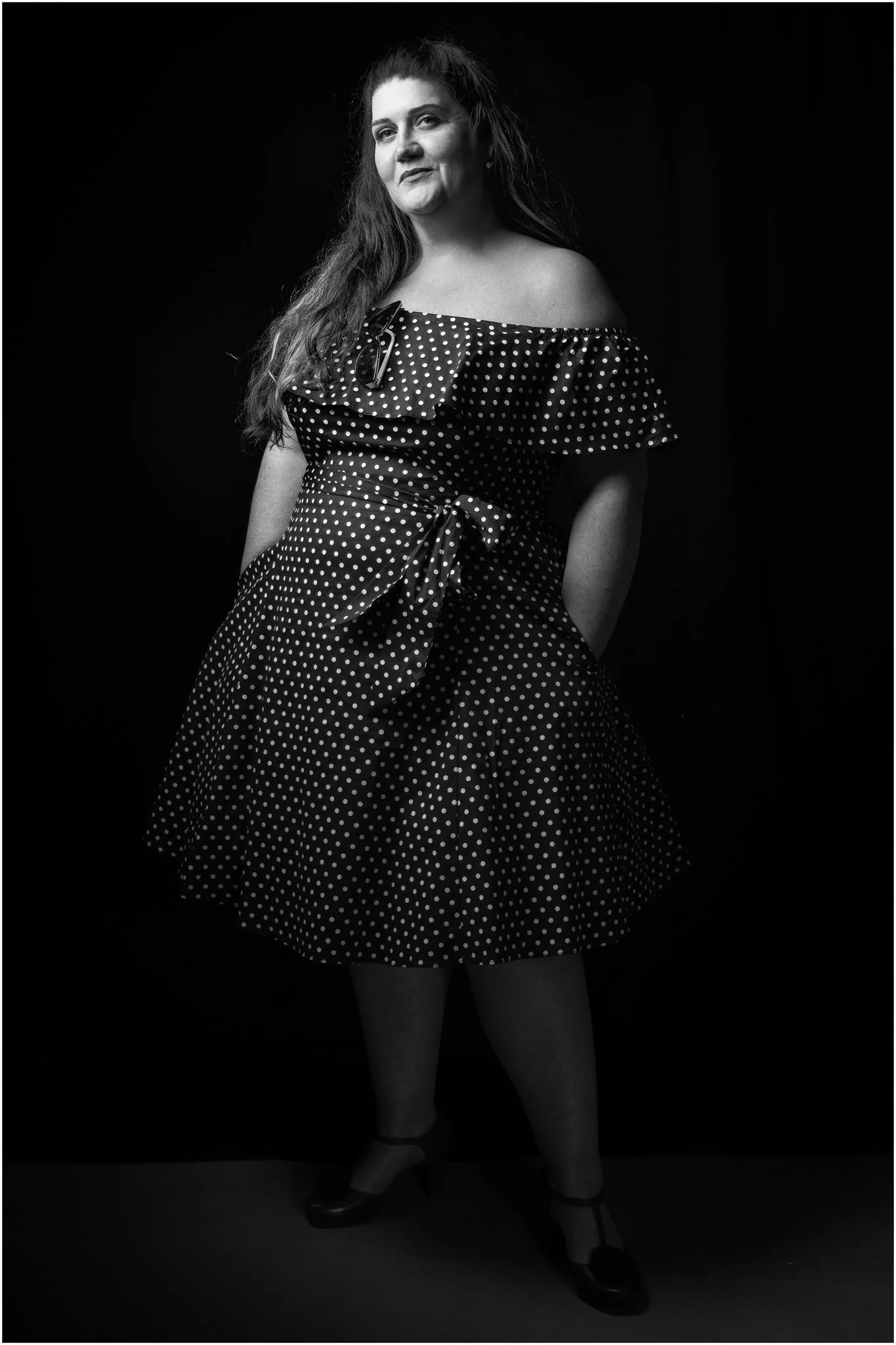 Black and white portrait of a woman in a polka dot dress