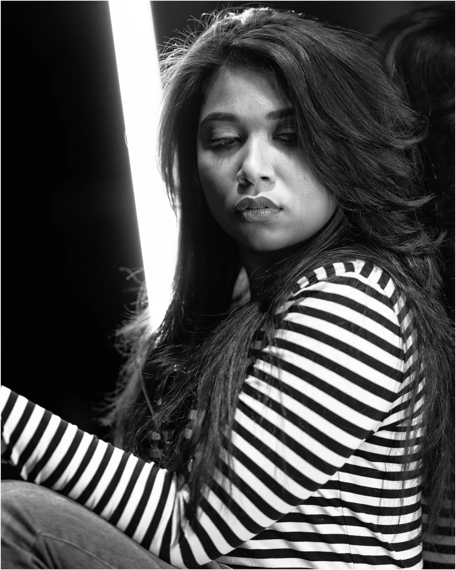 Black and white portrait of a woman in a striped top