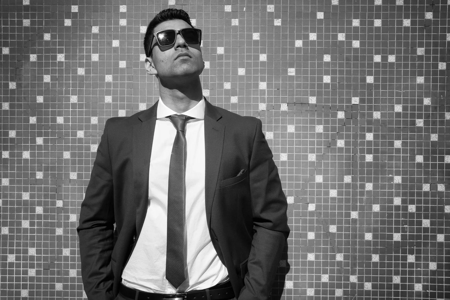 Black and white photo of a man in a suit and sunglasses