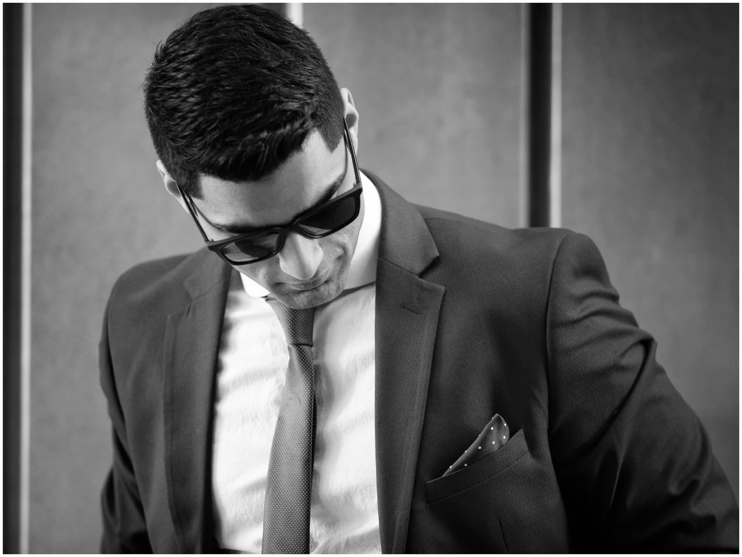 Black and white photo of a man in a suit and sunglasses