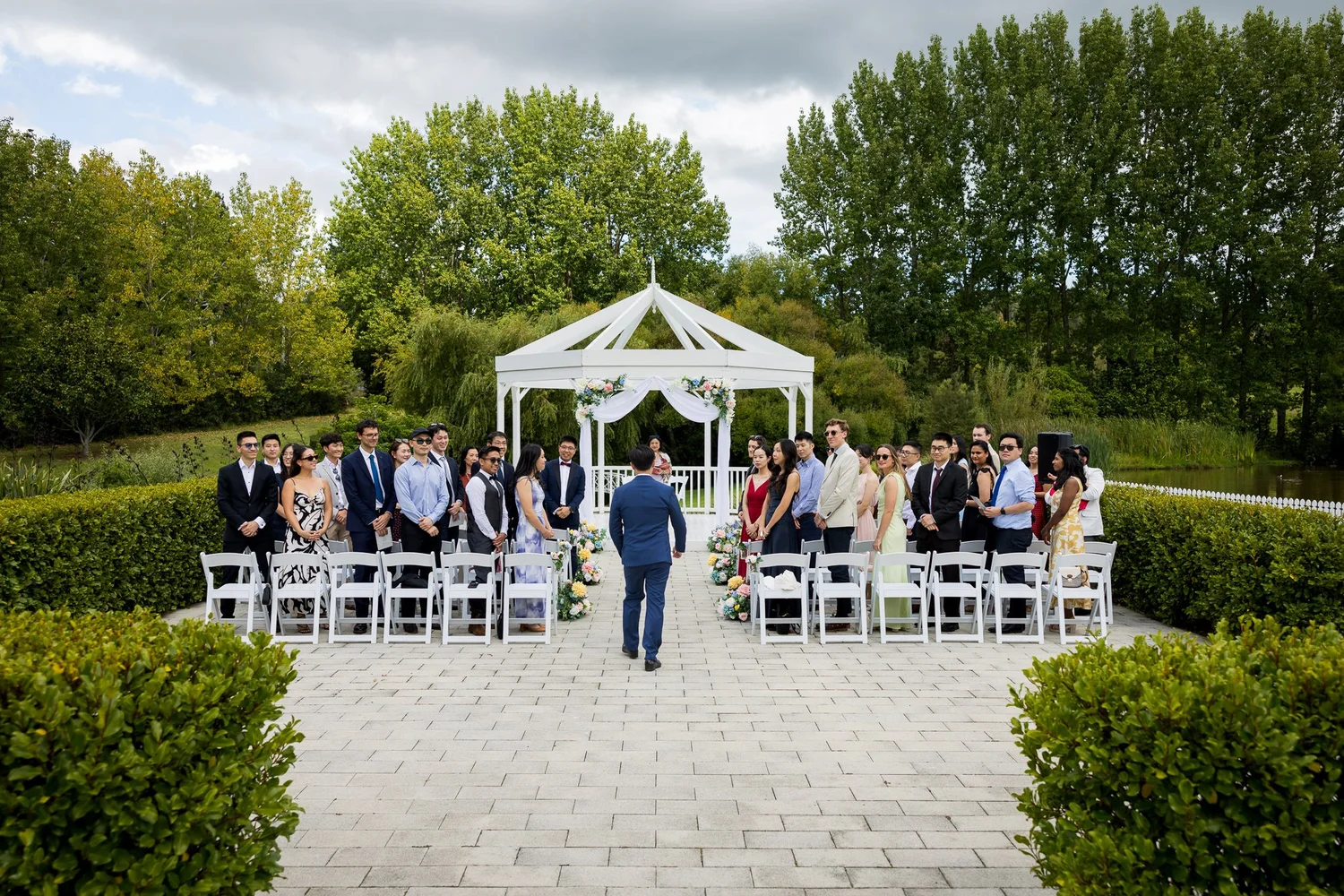 Guests gathered for a ceremony at the white gazebo