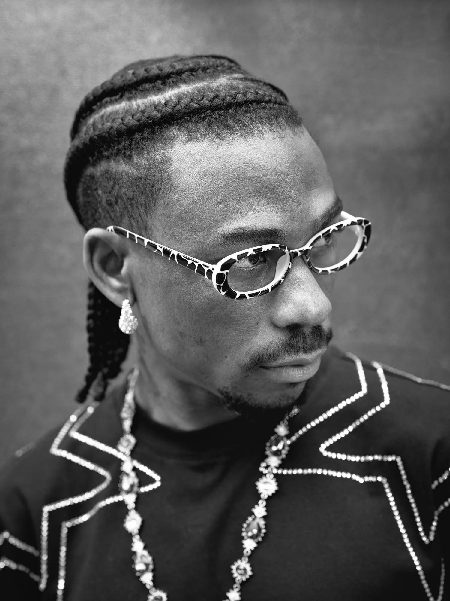Black and white portrait of a man in patterned glasses