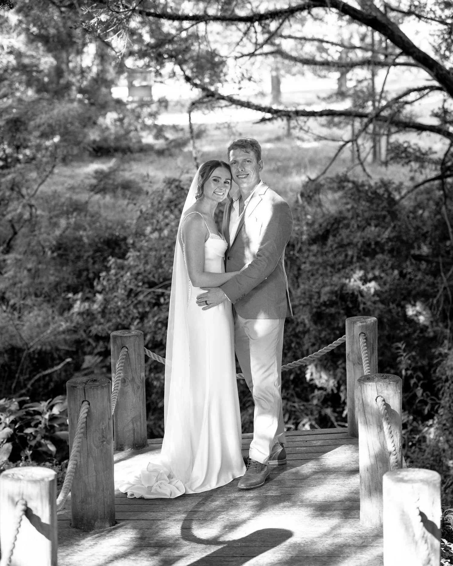Black and white photo of Jade and Ben on a wooden bridge