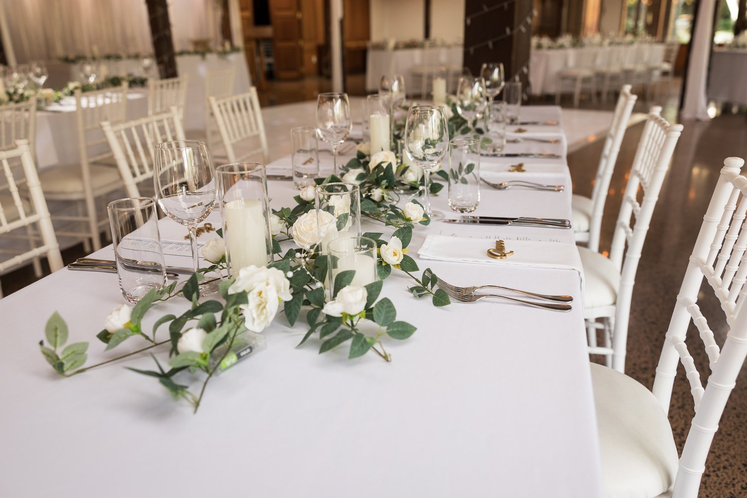 Reception tables set with white flowers and candles