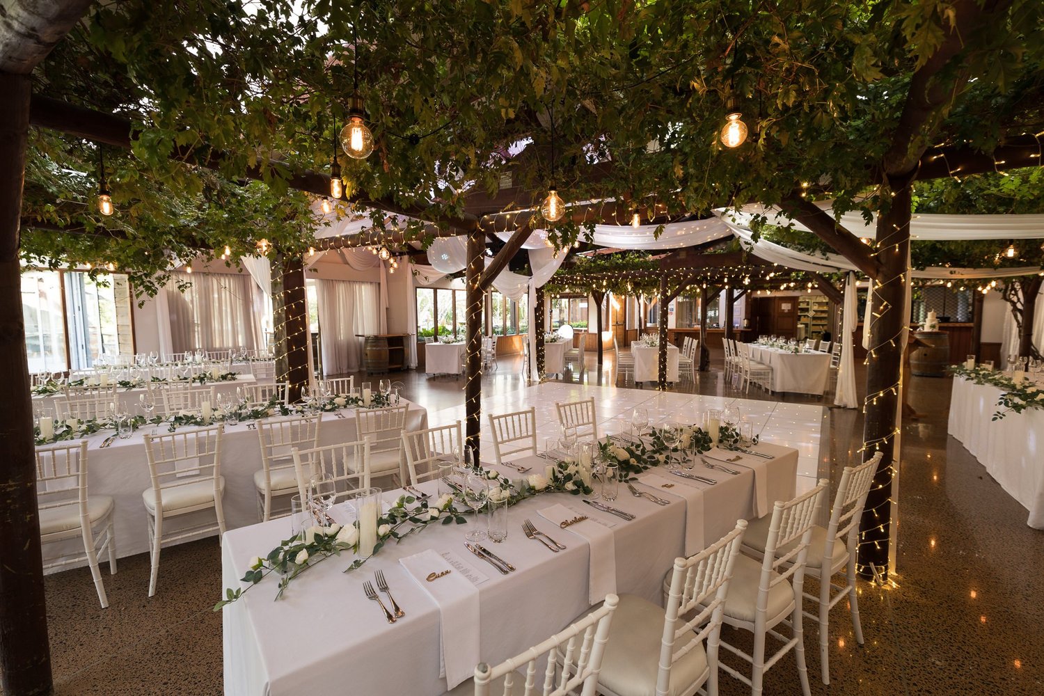 The reception room at Markovina set beneath a leafy pergola