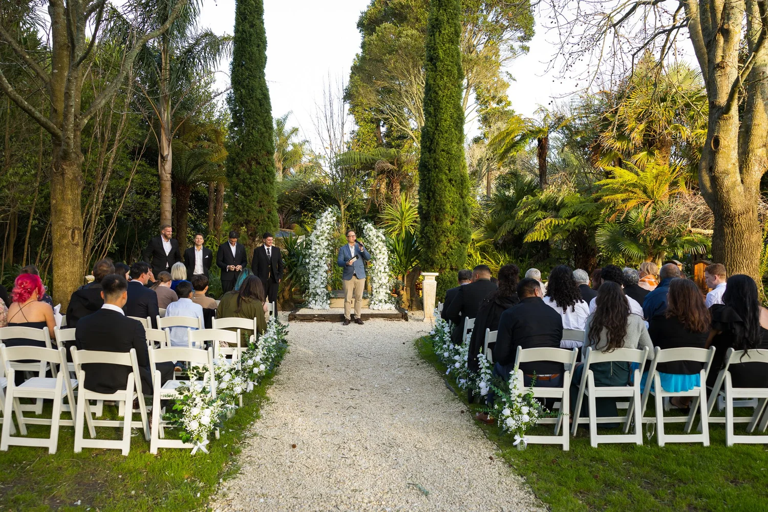 Guests seated for a ceremony among tall trees at Markovina Vineyard Estate