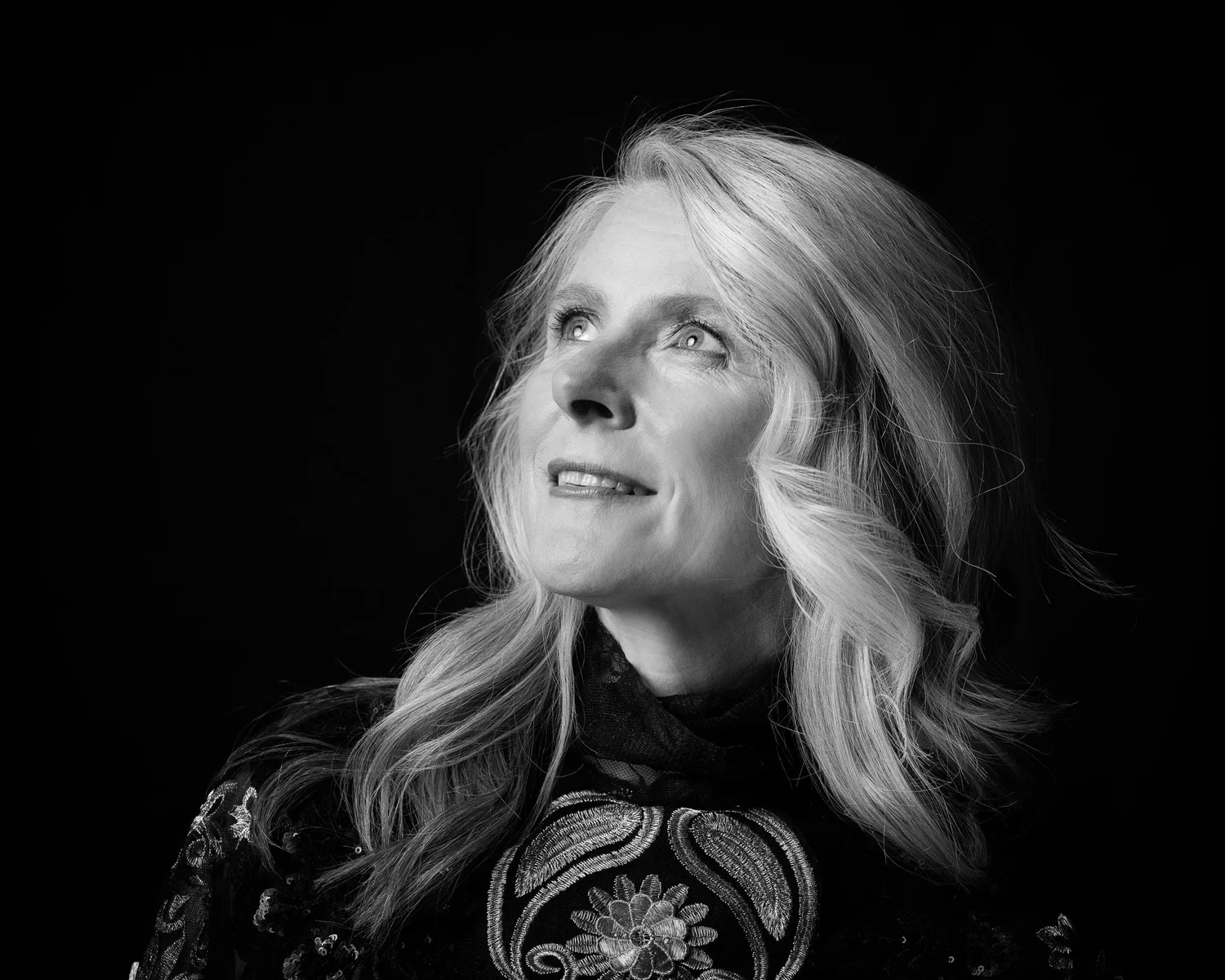 Black and white portrait of a woman looking upwards