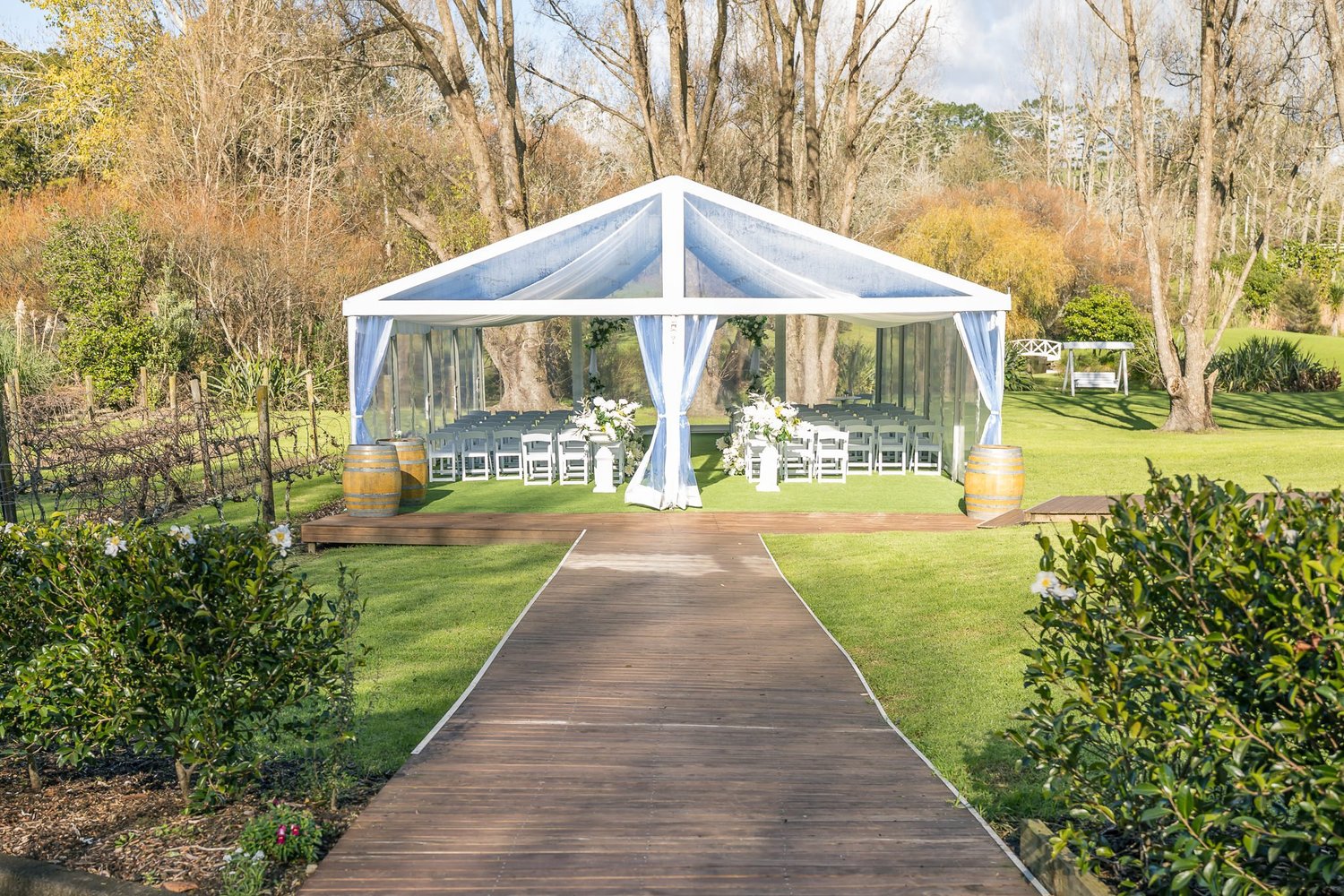 A path leading to the clear ceremony marquee in the gardens at Abel Estate