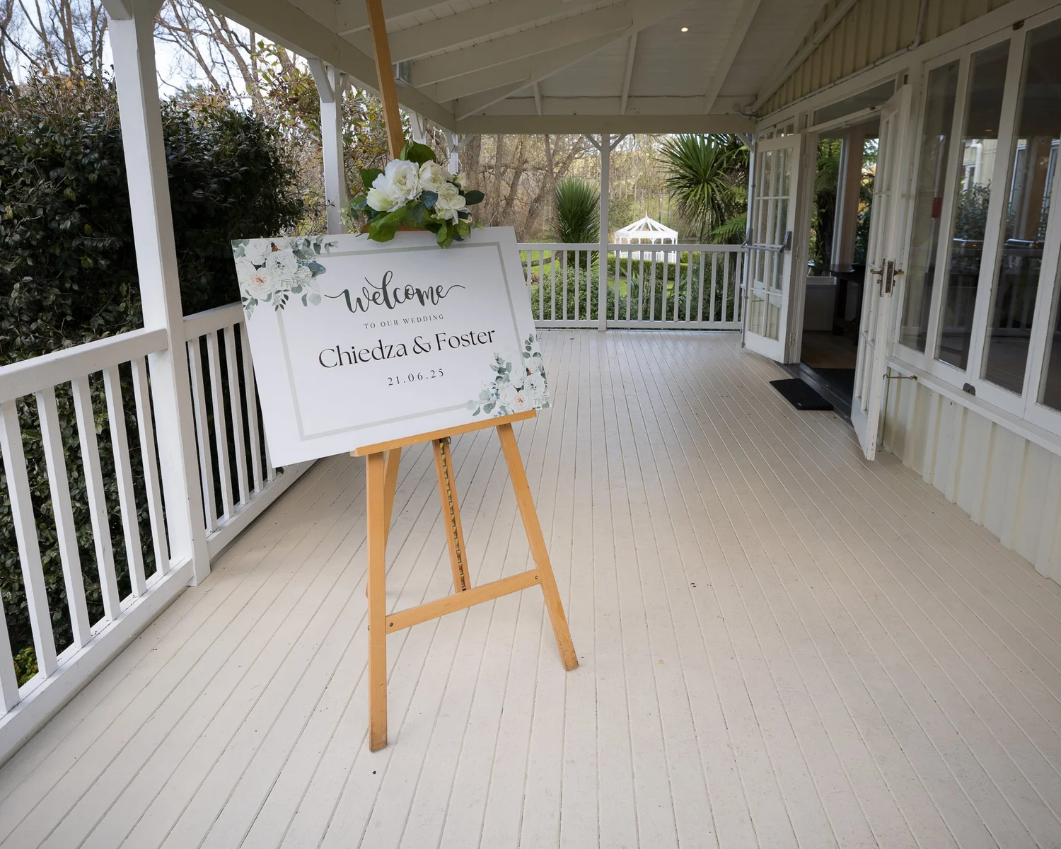 A welcome sign on an easel on the veranda