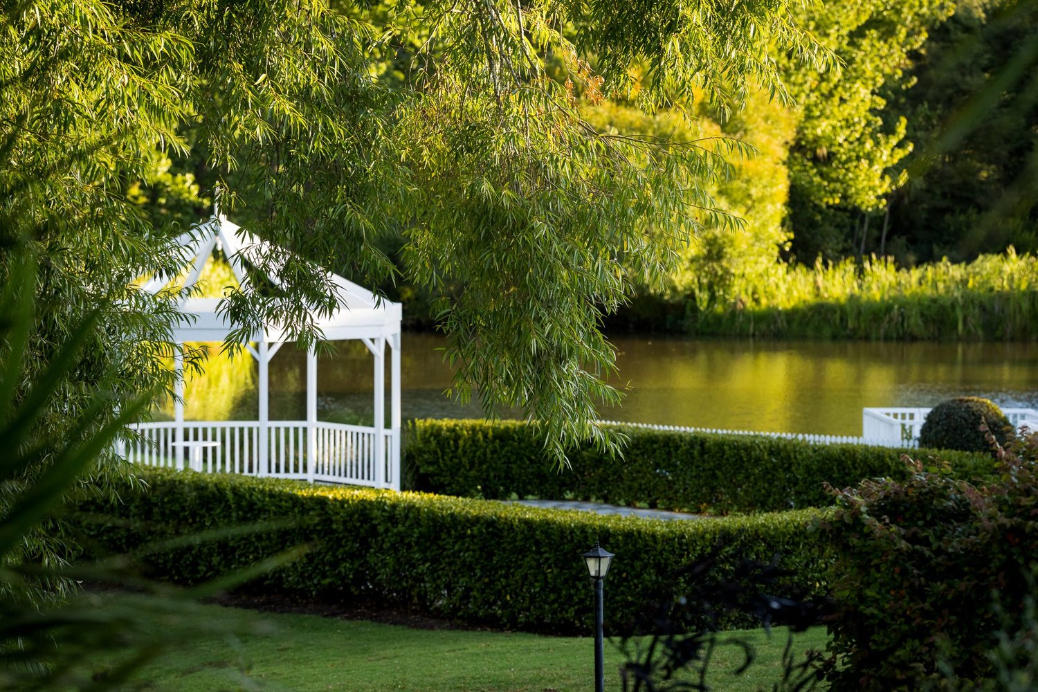 The lakeside rotunda among greenery at Abel Estate