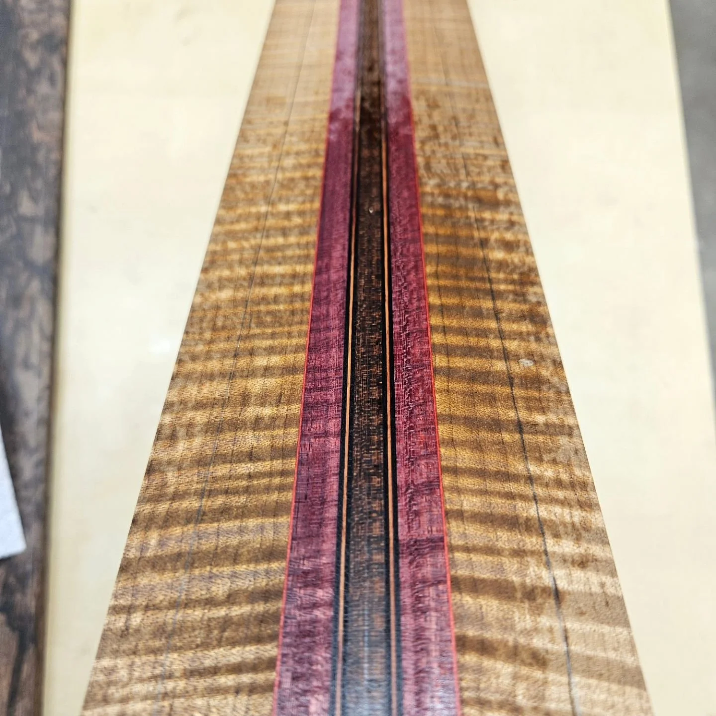 Gluing up neck blanks. This is the neck and beautiful landscape ebony fingerboard for the 7 string headless/ partial fretless/ sustaniac craziness. The neck is snakewood, flamed purple heart, flamed roasted maple, and some black, pink, and tulipwood 