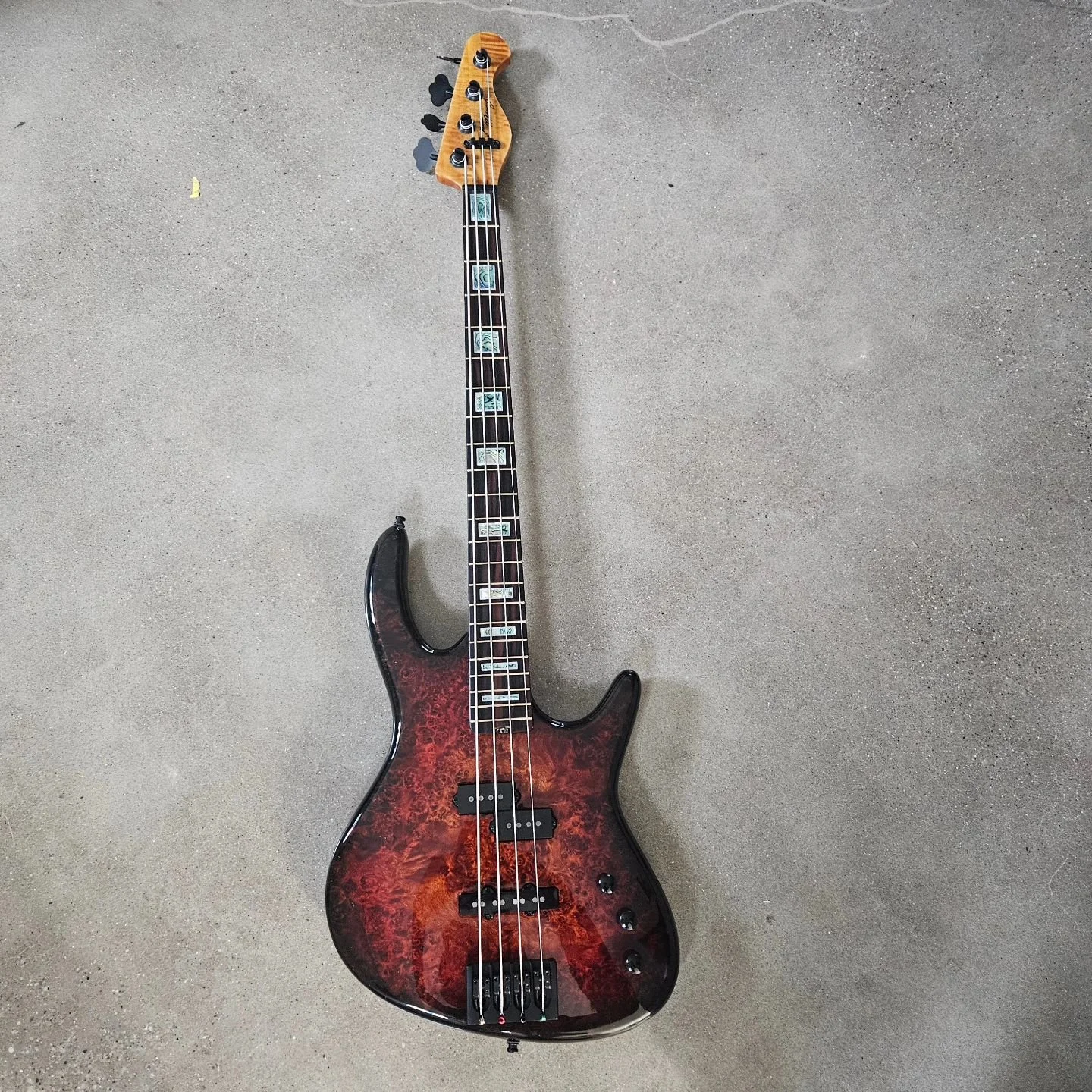 Grog #16. This bass is a little different from my usual aesthetic. It's a full custome design. The customer wanted something a little more fender-esq than my normal builds, so this is what we drew up. It's a burl poplar bent top with an alder body an