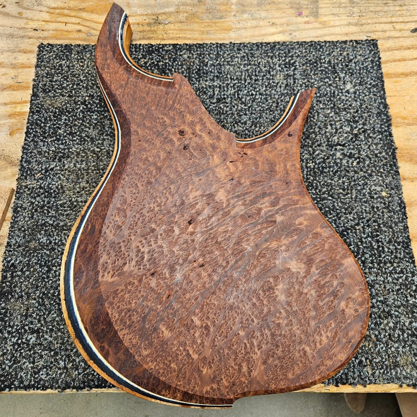 Coming soon! 3 new Grog Mammoth basses just off the CNC. All of them have Spanish cedar cores and different pinstripes.

1- Madrone burl top &amp; back, Black/Blue/poplar pinstripes 

2- Quilted maple top &amp; back, black pinstripe

3- Flame/quilt h