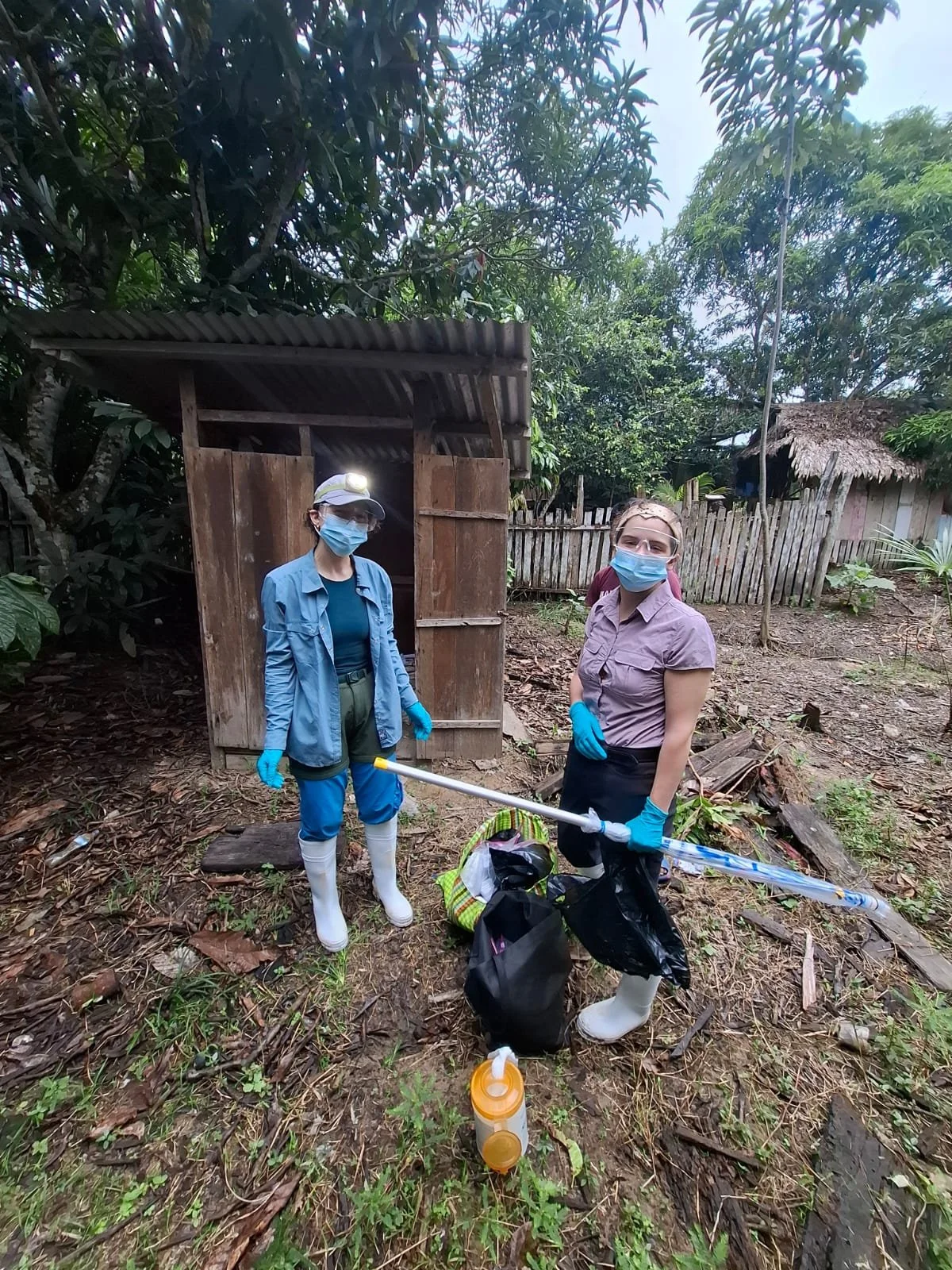 Hannah and Anna prepare to sample a household pit latrine in a community in the Loreto region of Peru in January 2026.