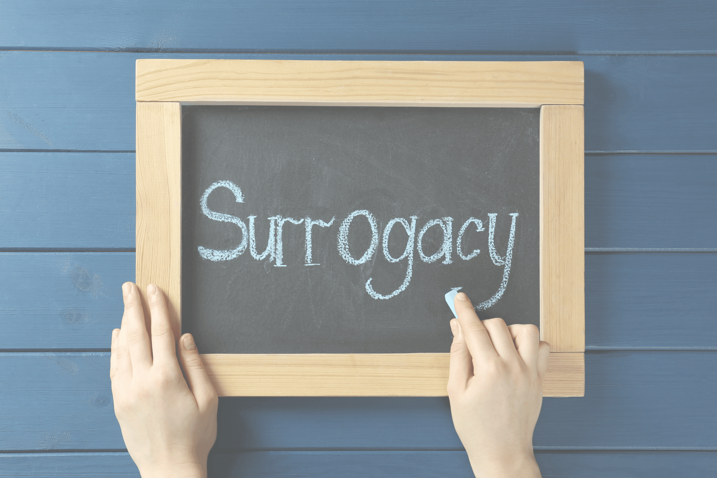 "Surrogacy" written on a blackboard.