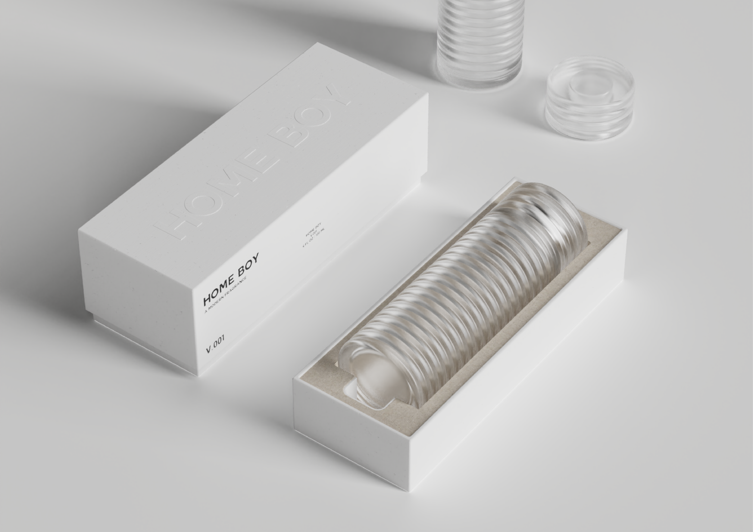 A minimalist packaging design featuring a white box labeled 'HOME BOY' with a transparent, ridged object inside, and additional transparent circular containers nearby.