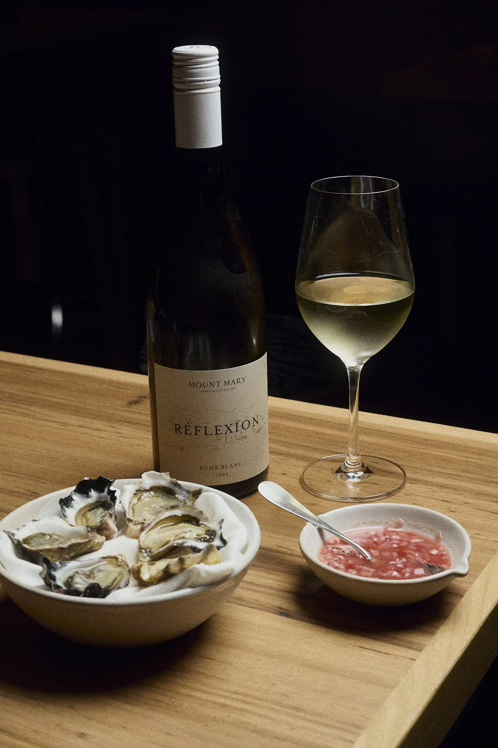 Wine bottle and glass with oysters