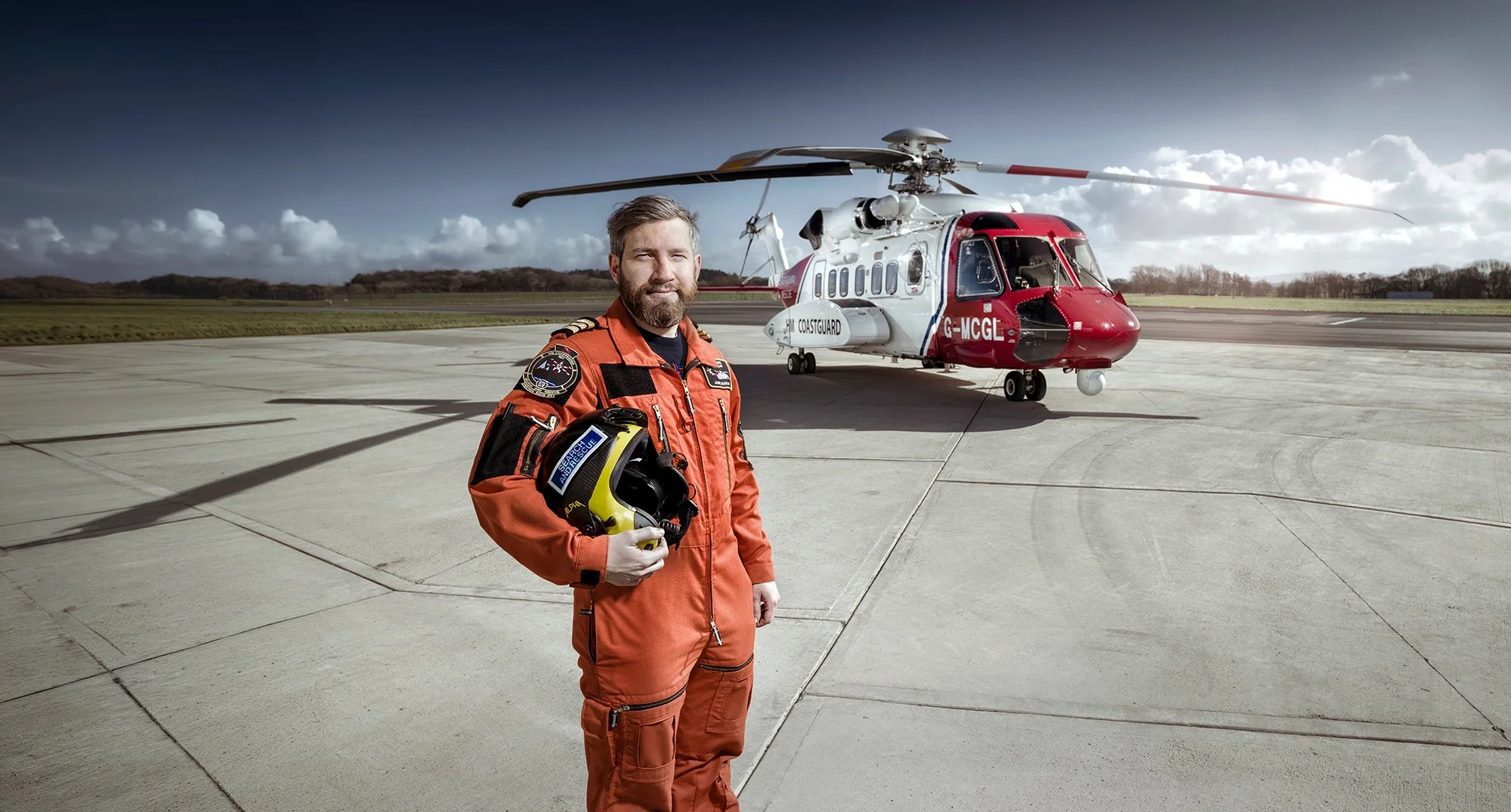 HM Coastguard Search and Rescue helicopter pilot in front of helicopter