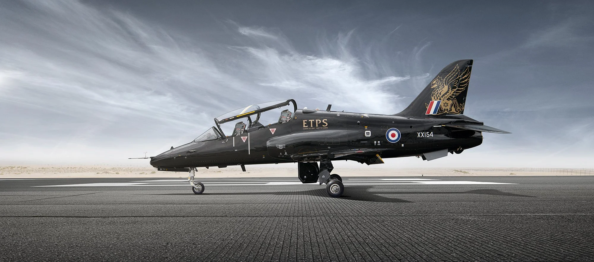Aviation photography of a Black coloured Hawk Jet side profile view.