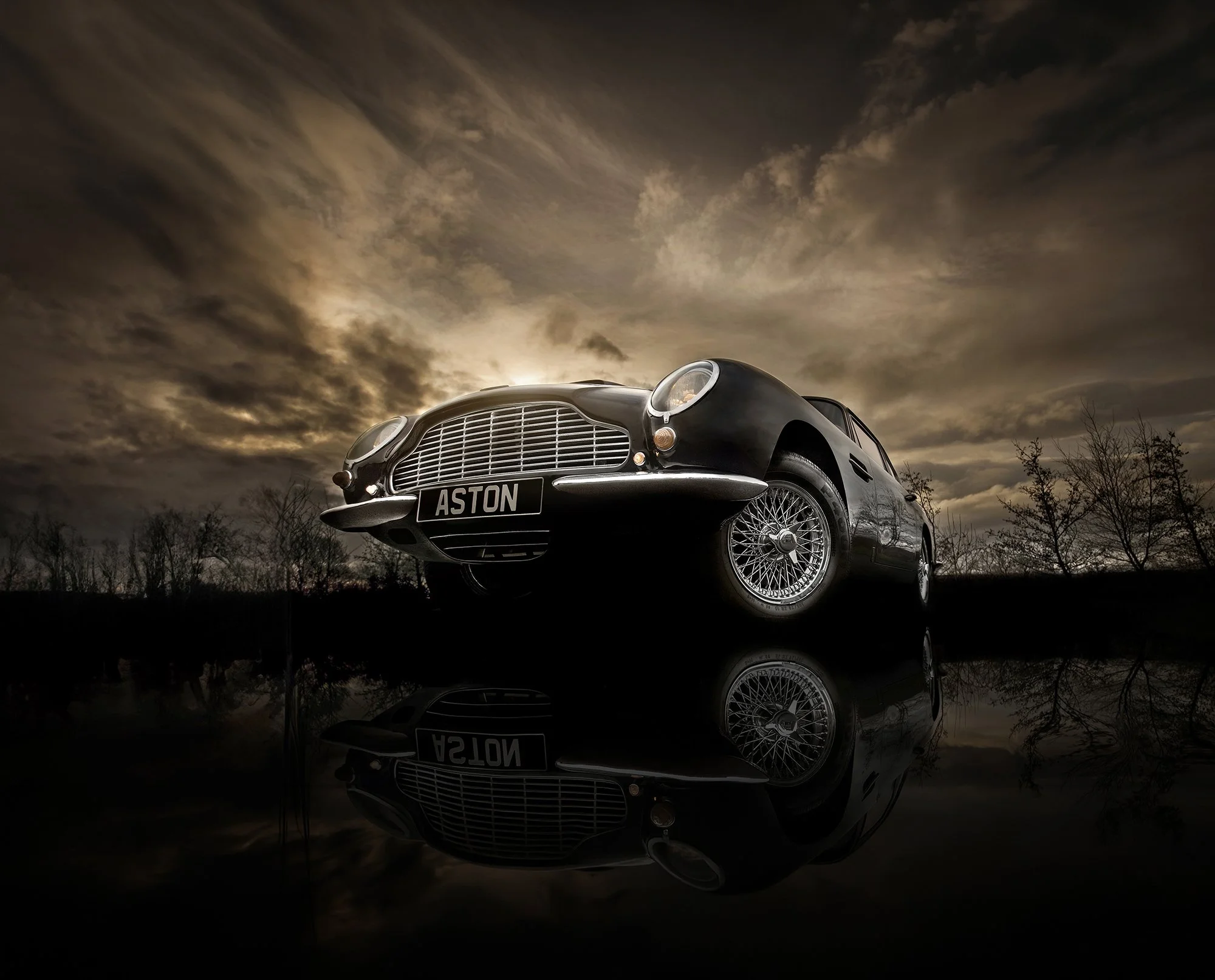 Aston Martin DB6 with sunset behind, car photography.