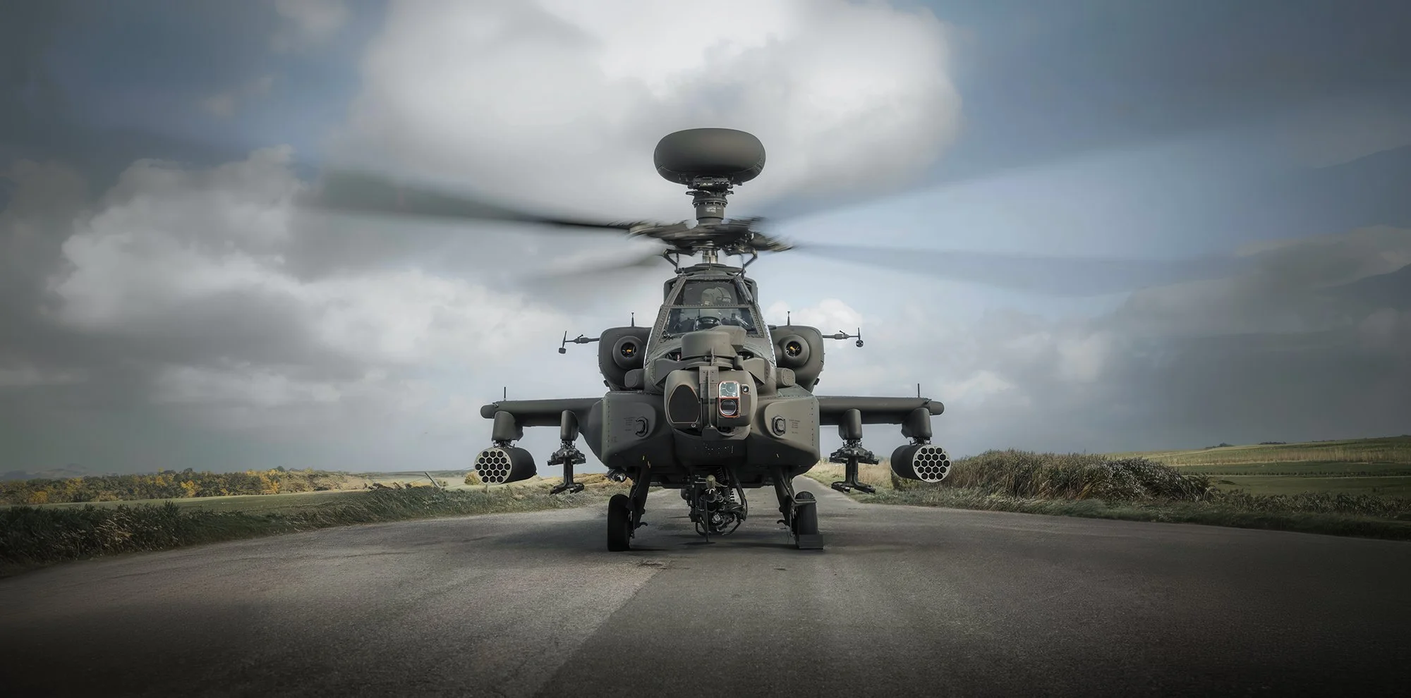 Apache helicopter landing on road 