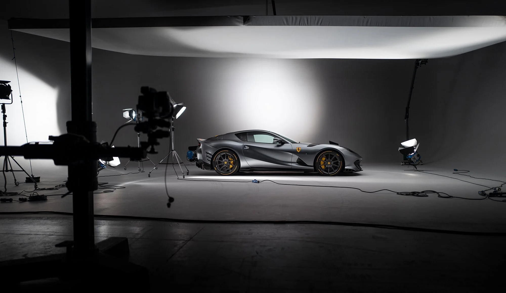 Behind the scenes image of a Ferrari being photographed in studio.
