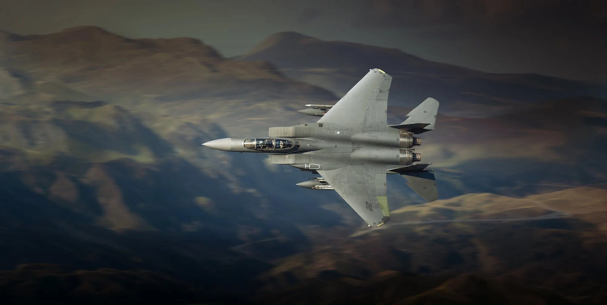 Low flying F15 with mountains in the background
