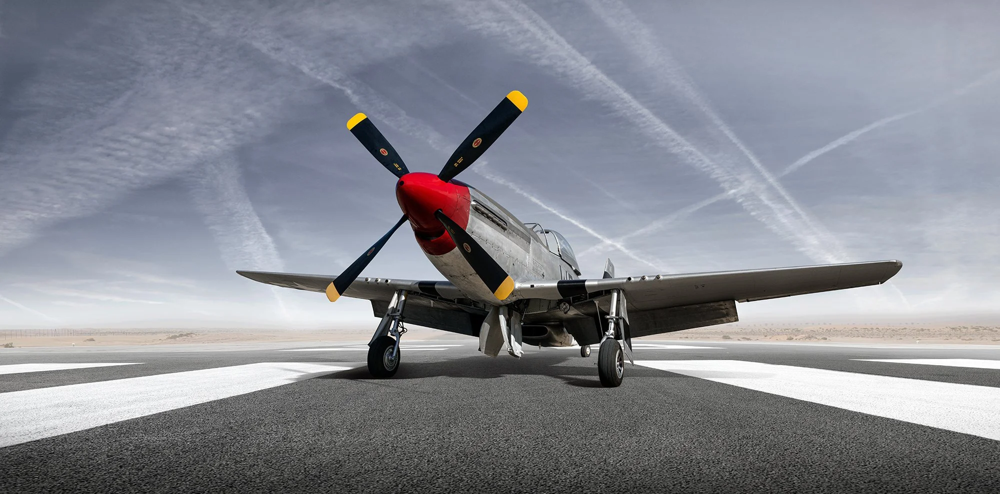 P51 Mustang aircraft, front view showing red noise cone, Aviation photographer, Tim Wallace.