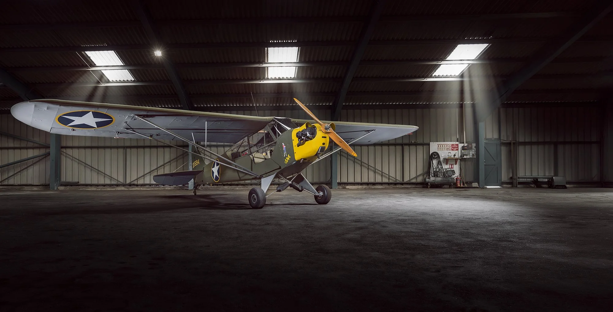Vintage Aircraft - Piper L4 Cub in old hanger