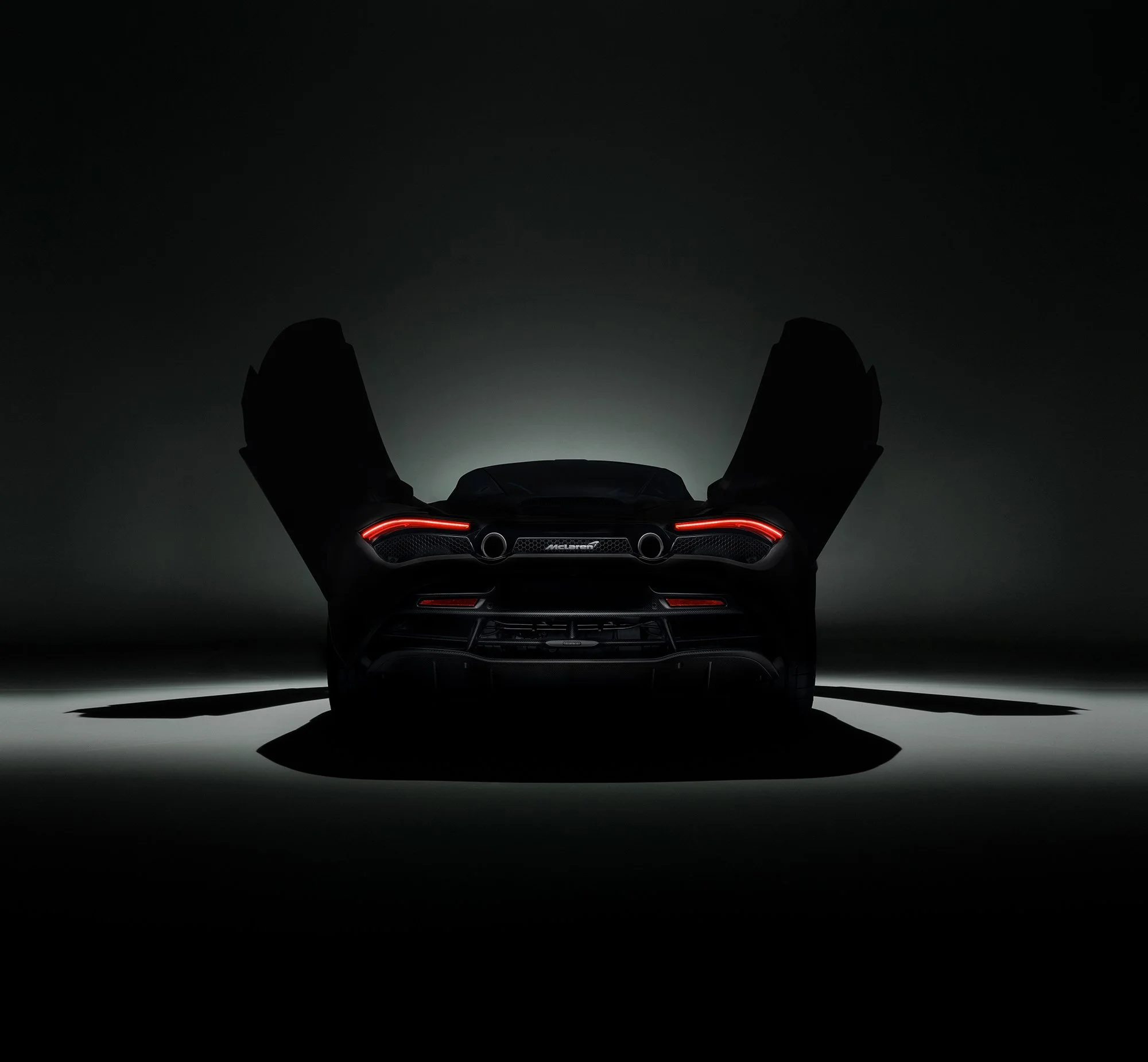 McLaren 720s, rear view of the car in the dark, studio car photography