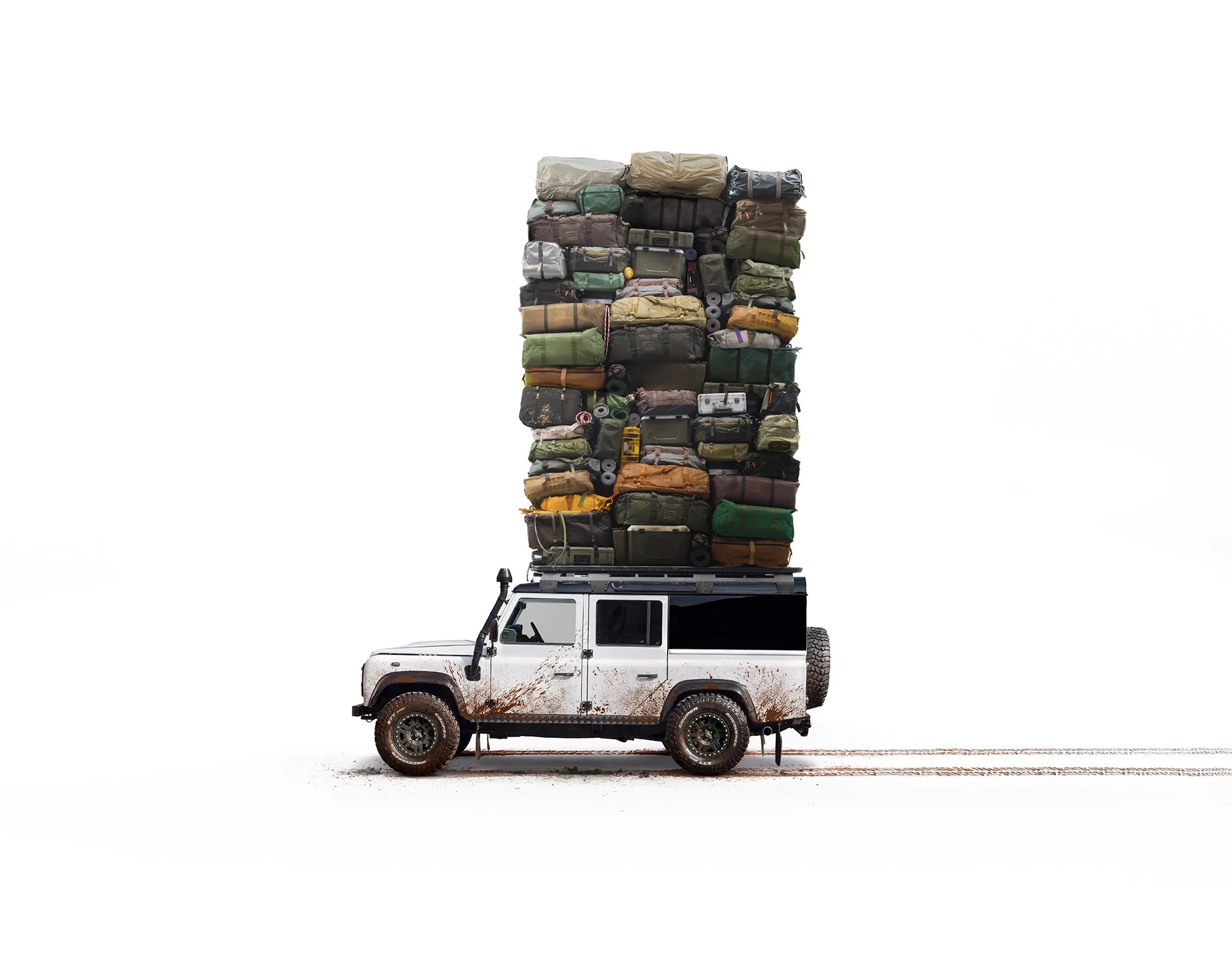 Land Rover Defender in white carrying lots of bags on roof rack