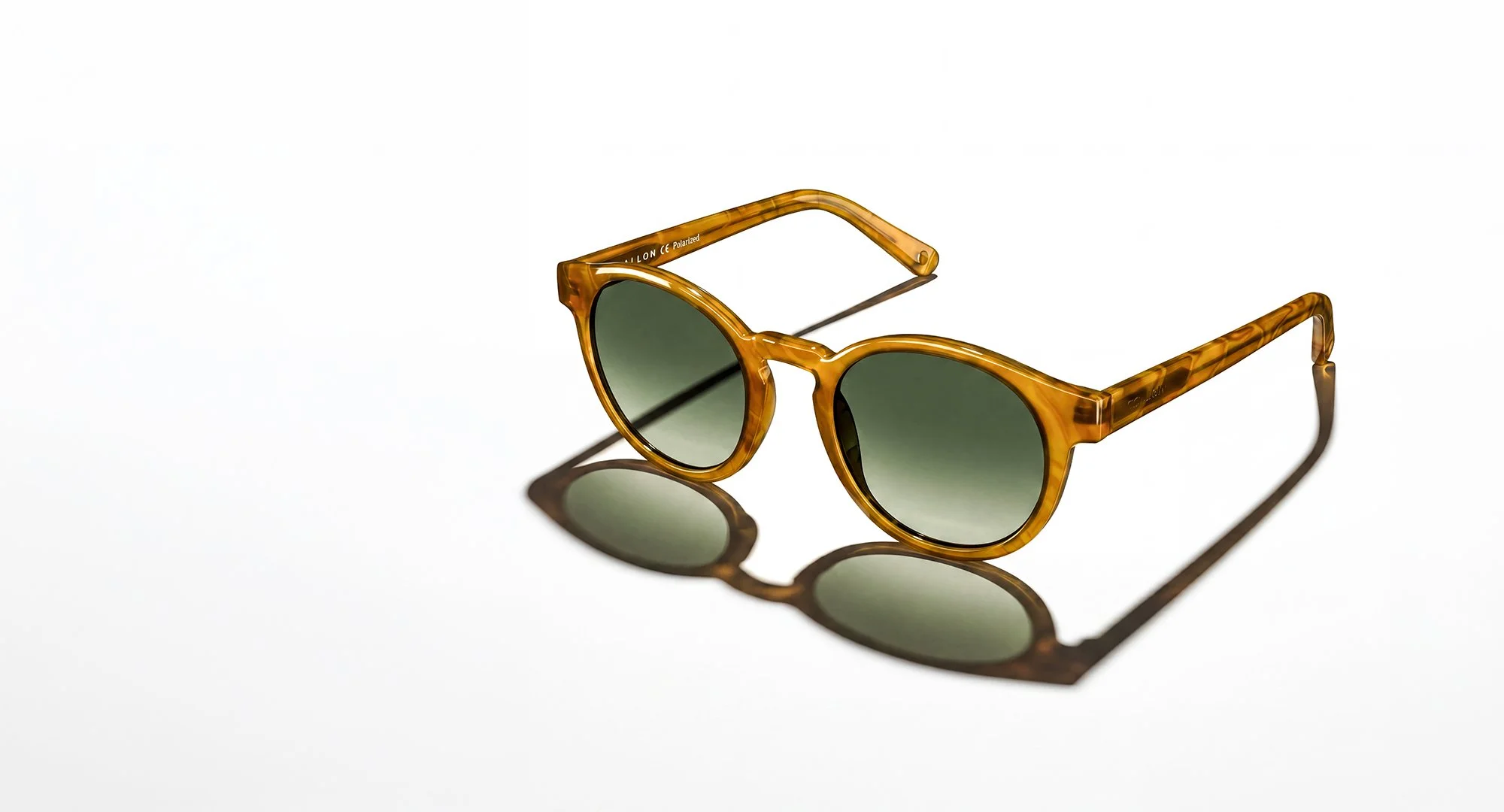 Green sunglasses on white background.