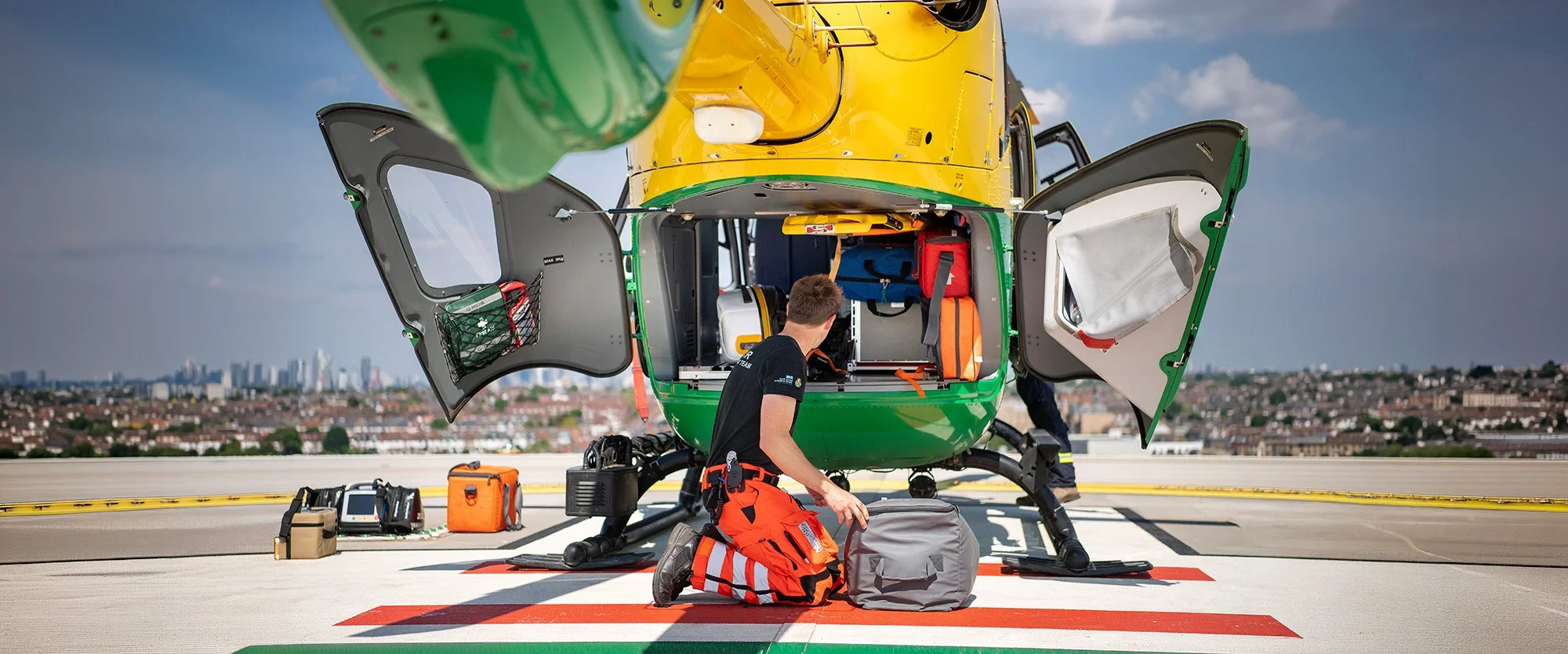 Air Ambulance Doctor loading helicopter on Hospital Landing Pad