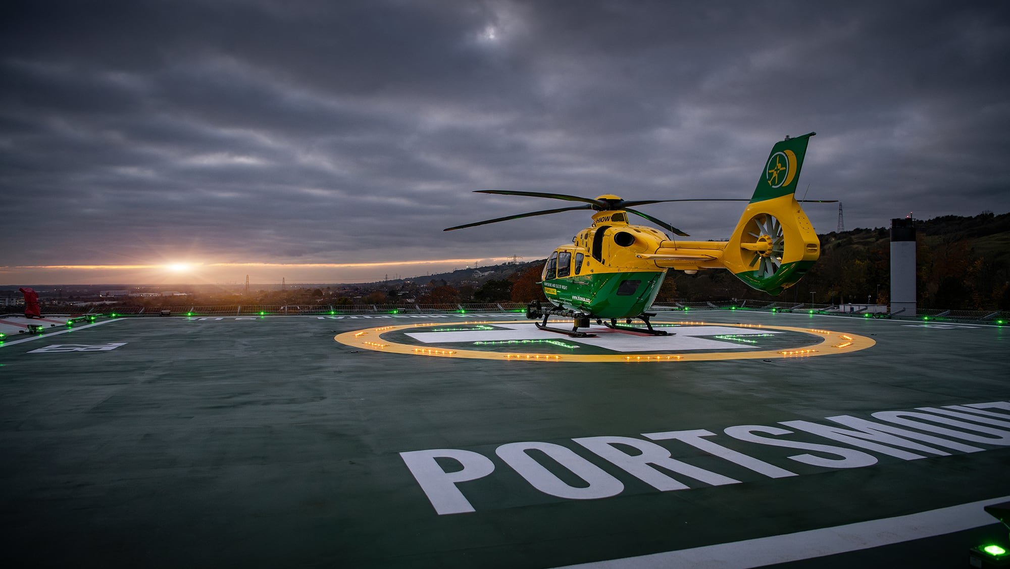 Air Ambulance Helicopter on Hospital Landing Pad as sun sets.