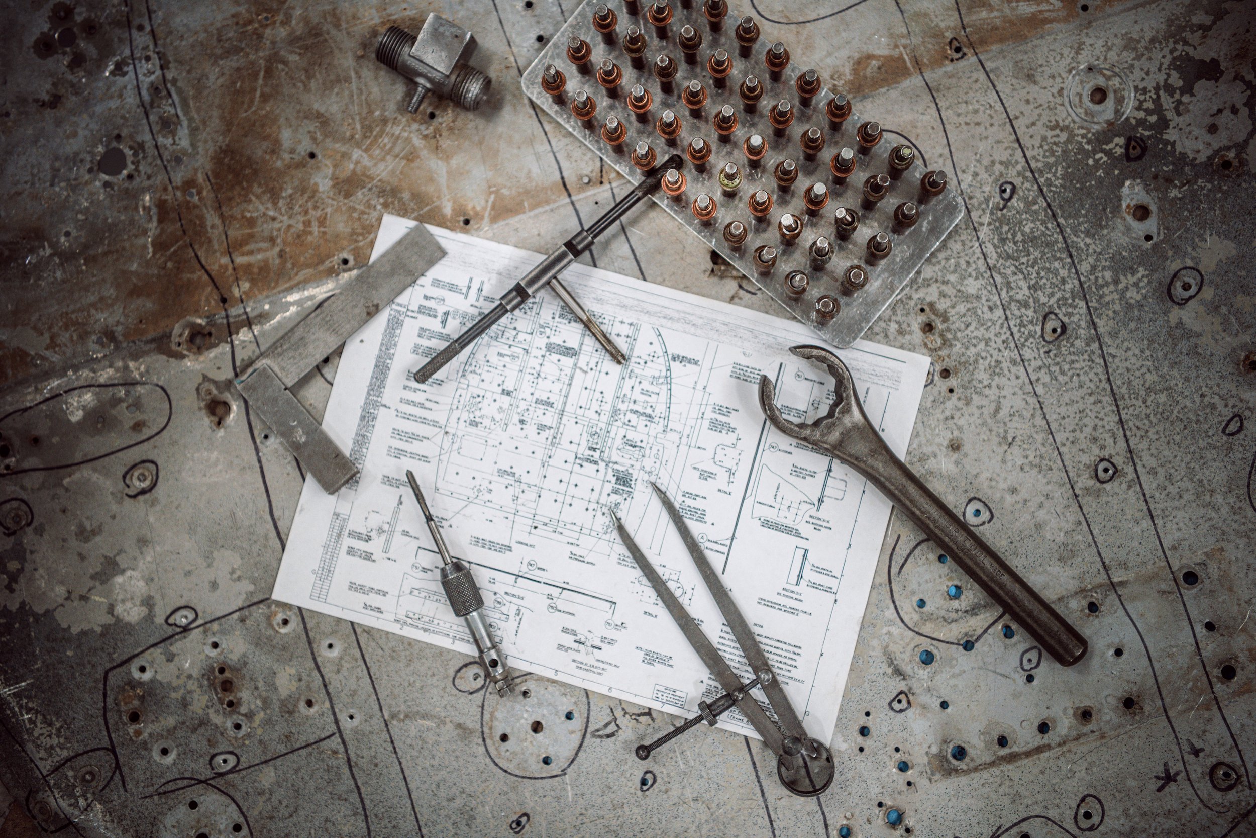 Engineering, Vintage aircraft tools sat on a work bench.