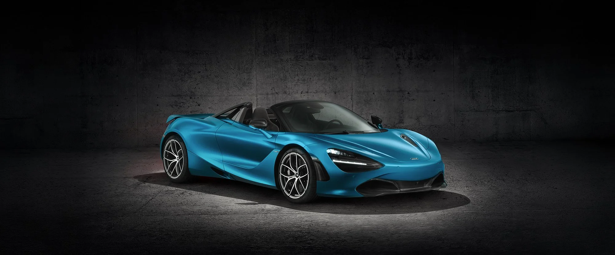McLaren 570s car in a dark studio setting.