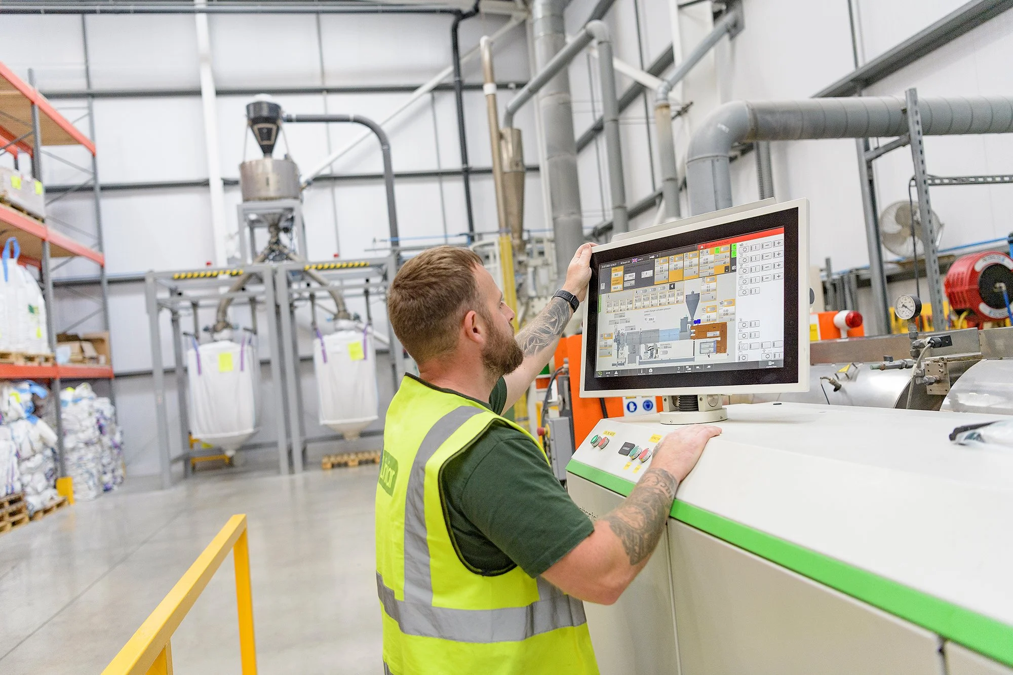 Engineer checking screen in a manufacturing plant.