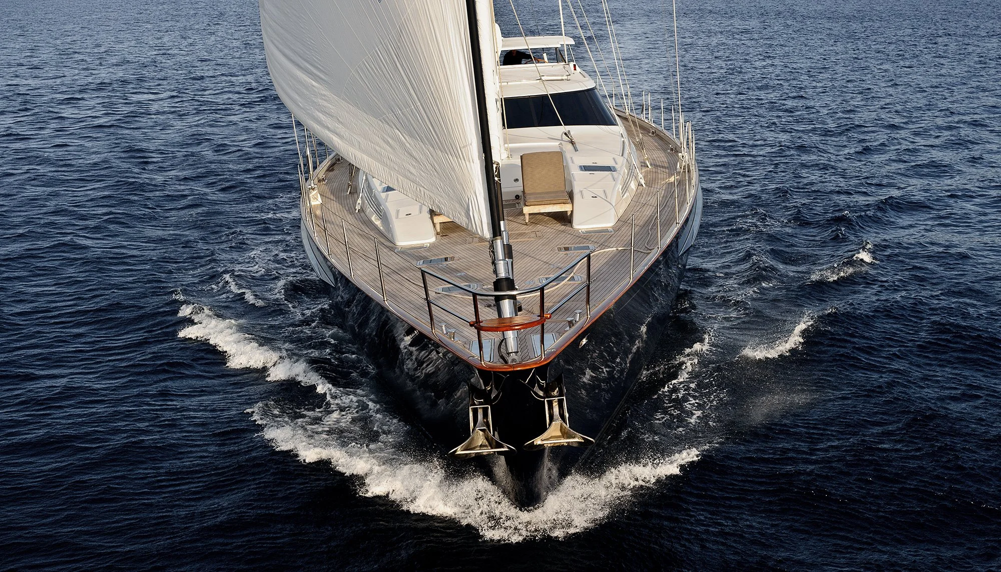 Luxury super yacht sailing across open water  