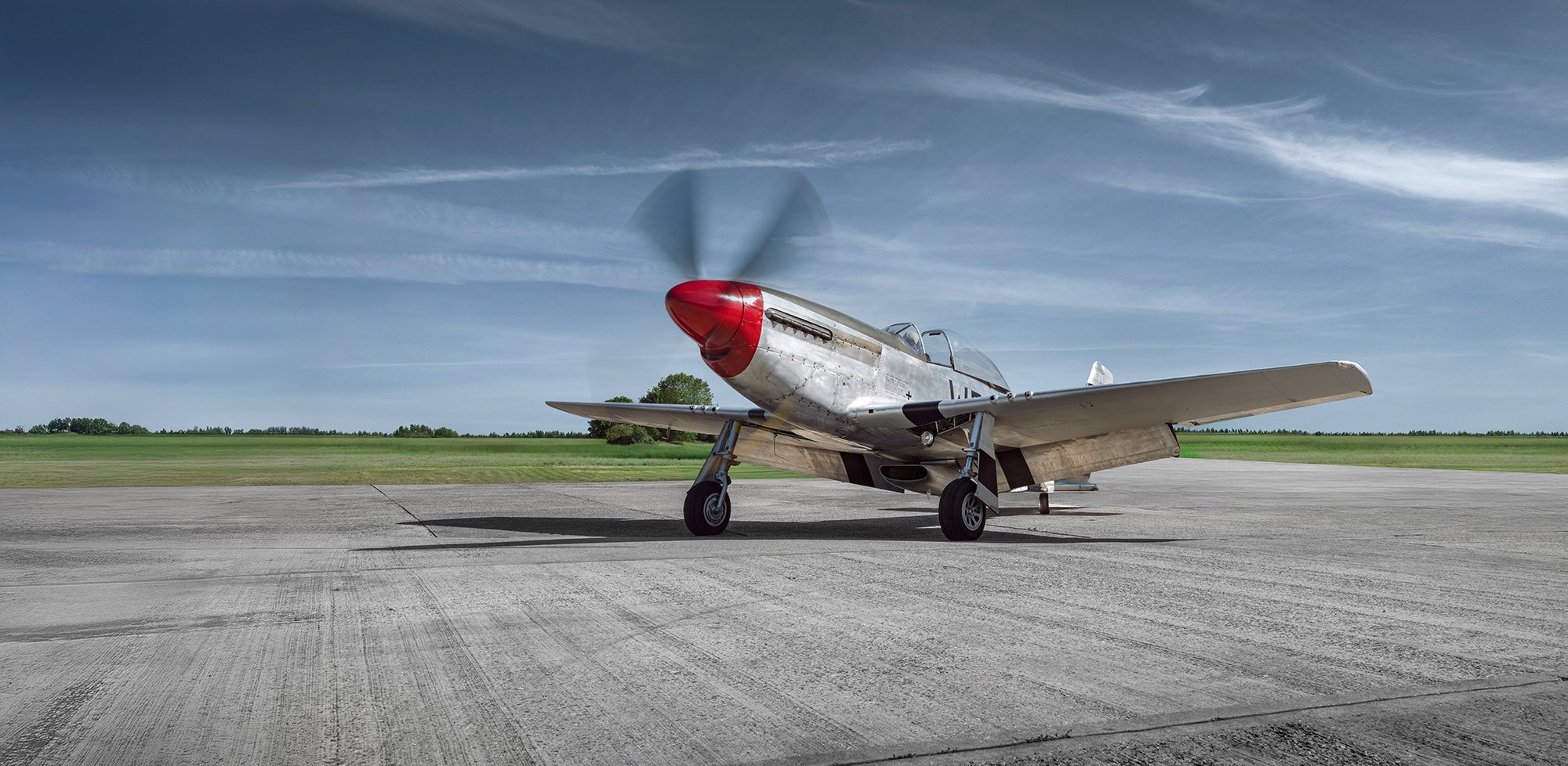 P51 Mustang aircraft, front view showing red noise cone, Aviation photographer, Tim Wallace.