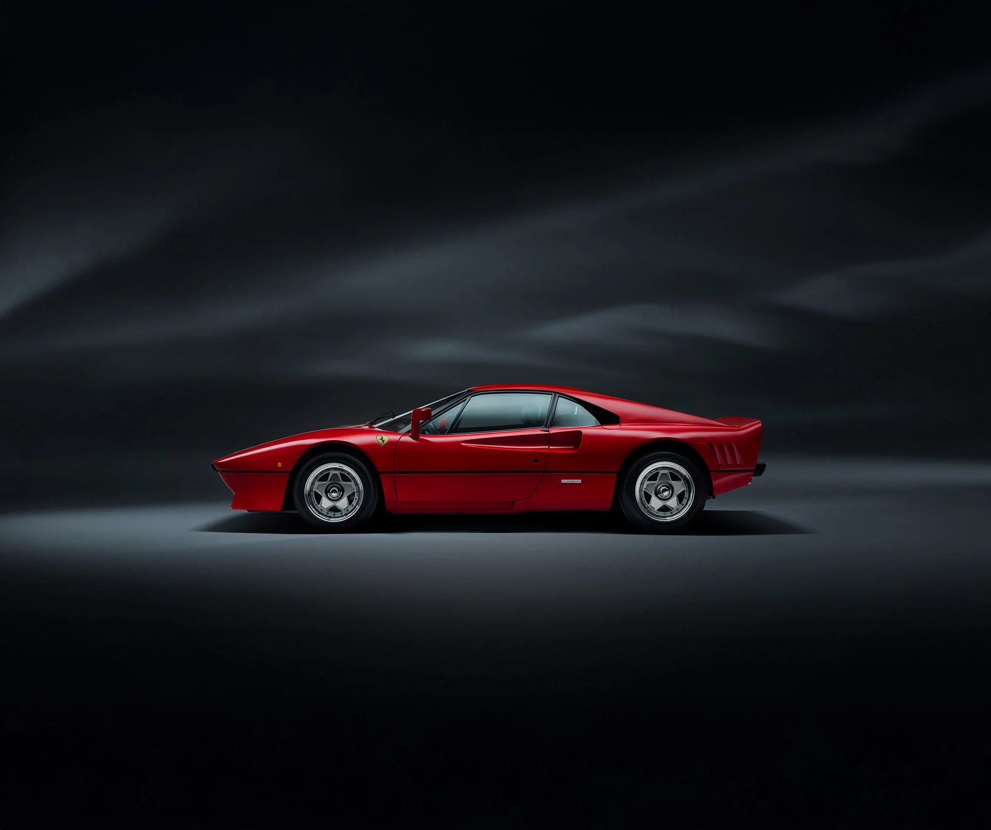 Ferrari 288 GTO profile view in studio, car photography.